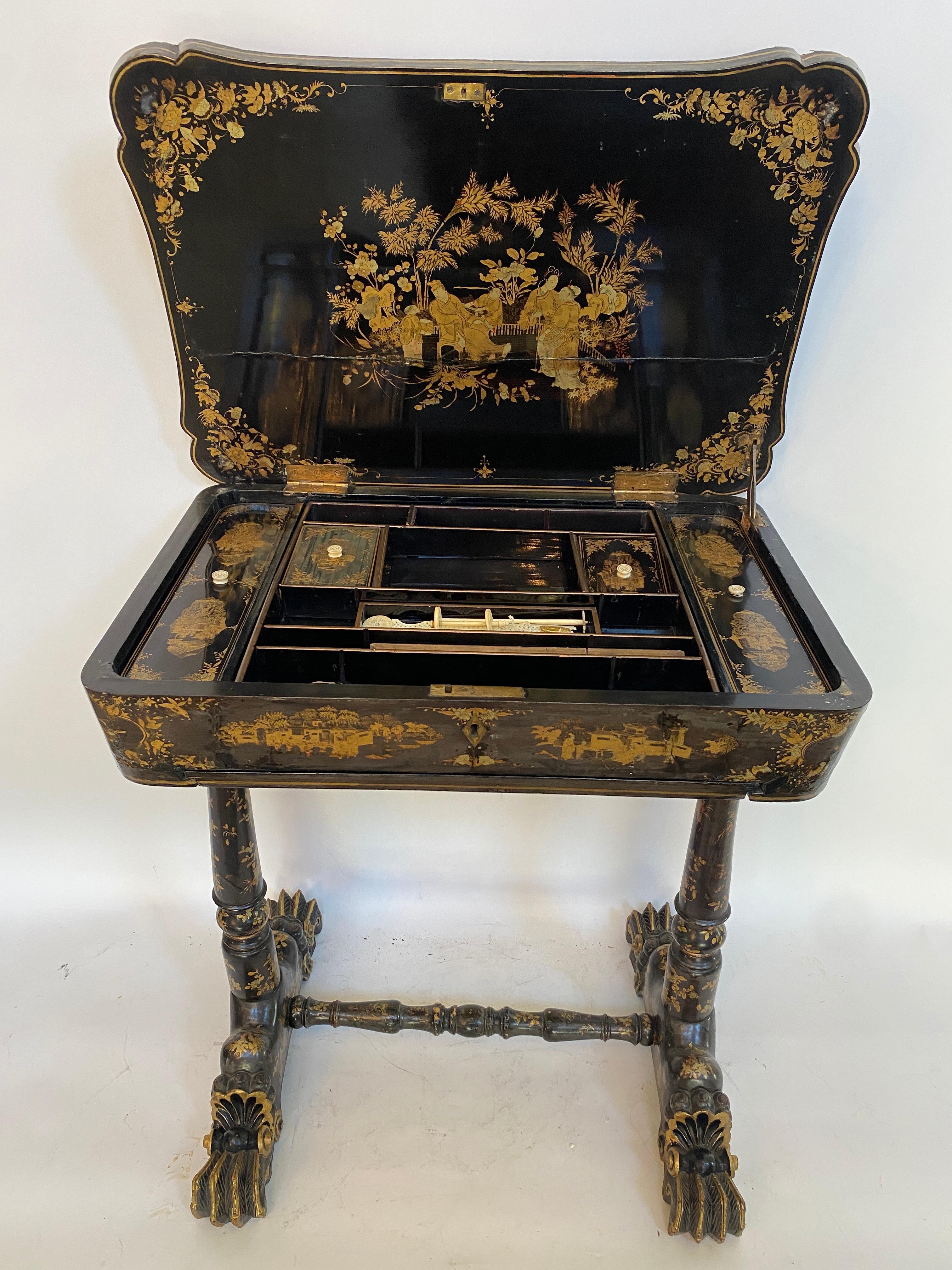 Early 19th century Chinese export lacquer and gilt sew working table from the Qing dynasty, with carved gilt dragon head feet, with the table of canted rectangular form, with mounded top, the entire finely decorated with the typical figural