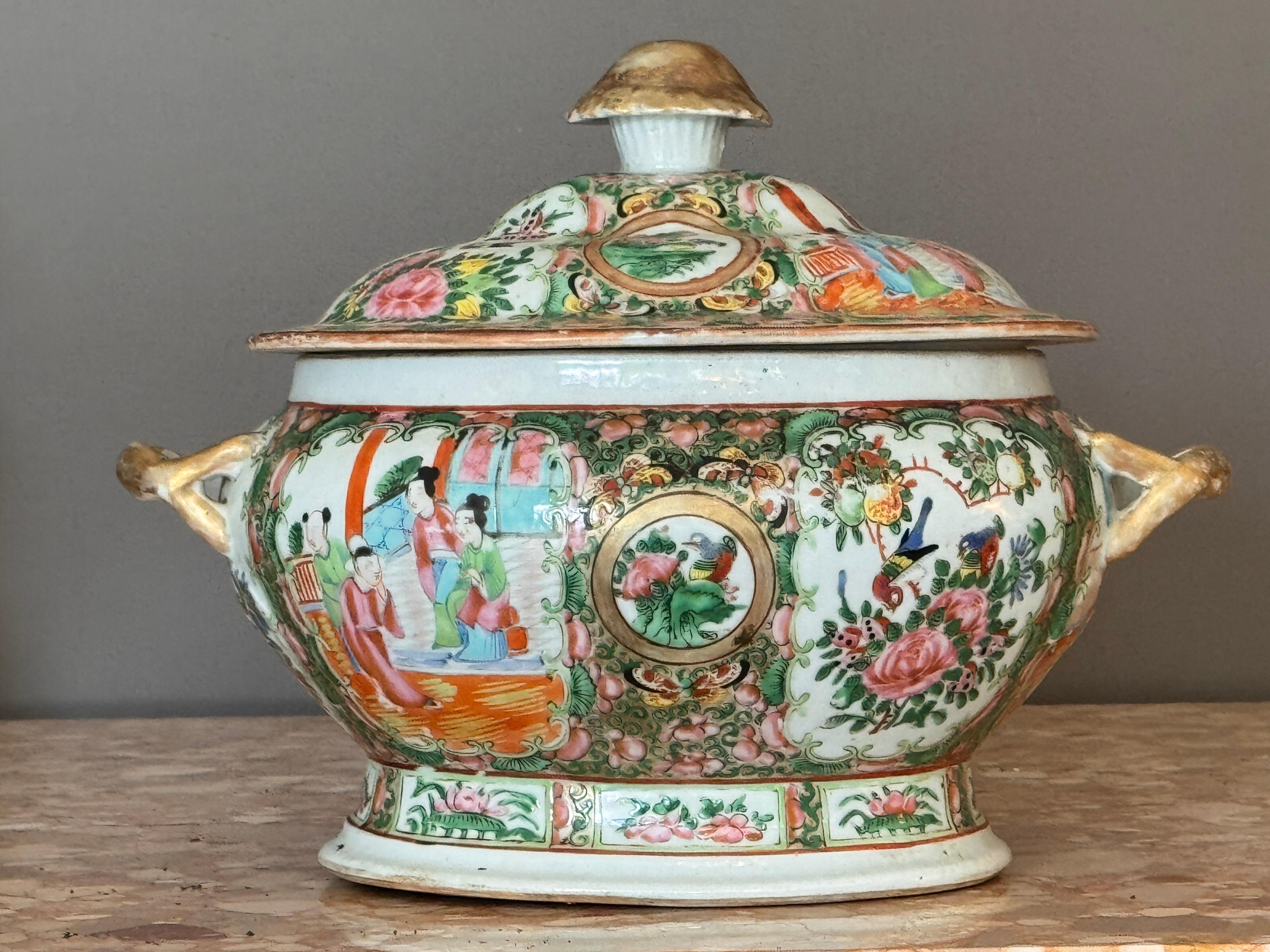 An early 19th century Chinese export porcelain soup tureen in the Rose Medallion pattern, richly decorated with alternating figural and floral panels framed by gilt accents. The domed lid and body are adorned with round medallions and vibrant
