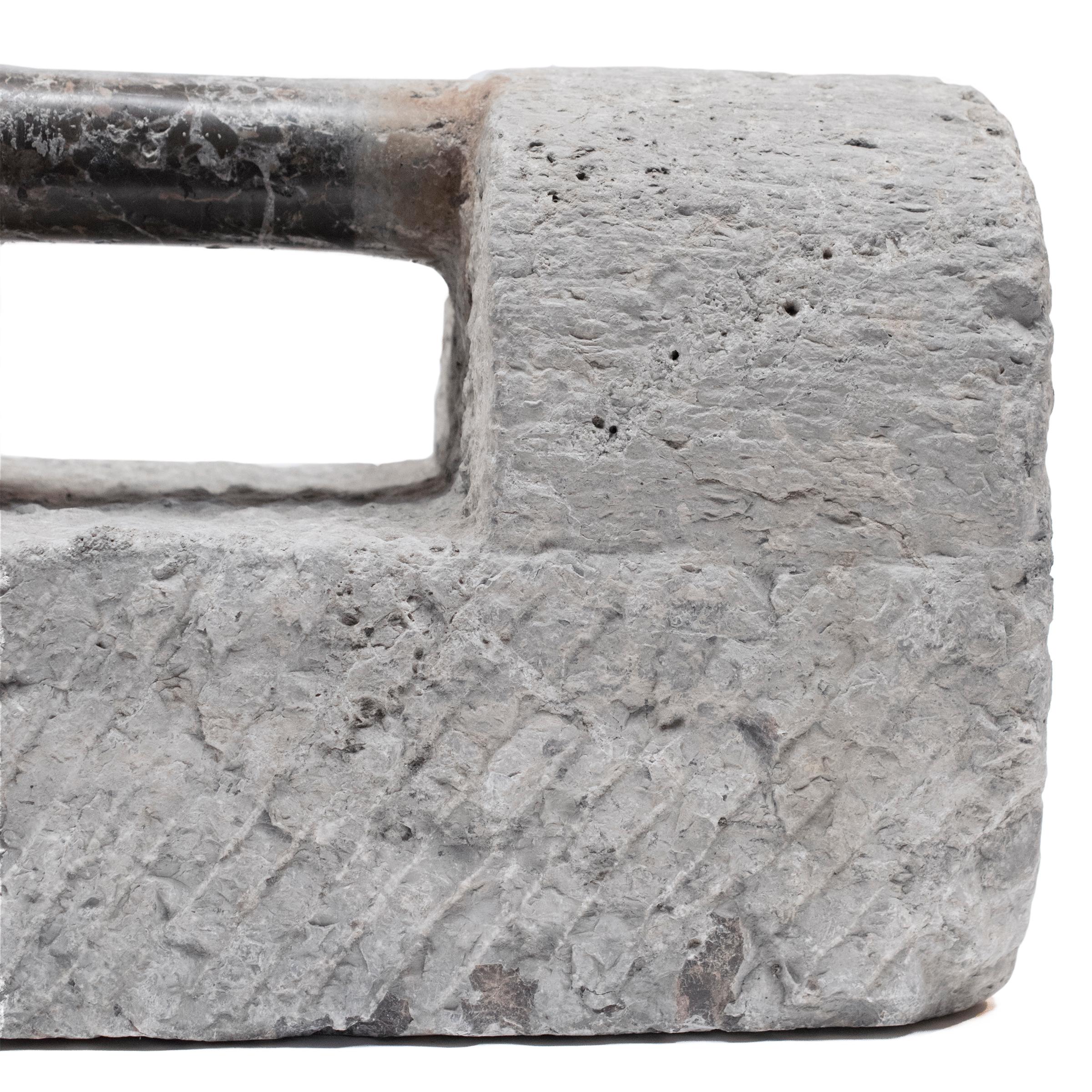 Used in intensive martial arts training, training weights such as this one made of limestone were shaped like ancient Chinese locks but were used much like modern dumbbells. Students would grip the handle and either swing the weight around or use