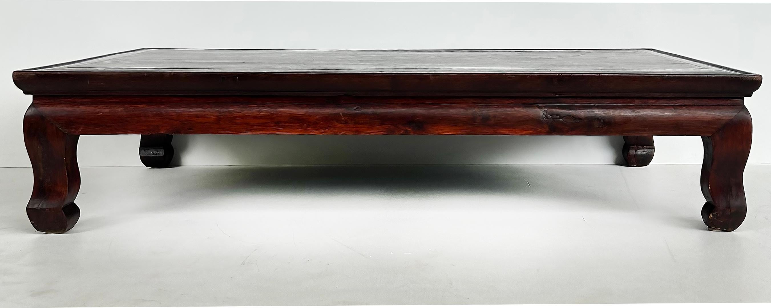Early 19th Century Chinese Kang Low Coffee Table

This is a vintage-style Chinese wooden low table with a rectangular top, featuring a dark polished finish. The table is supported by four curved, sturdy legs, giving it a classic and elegant
