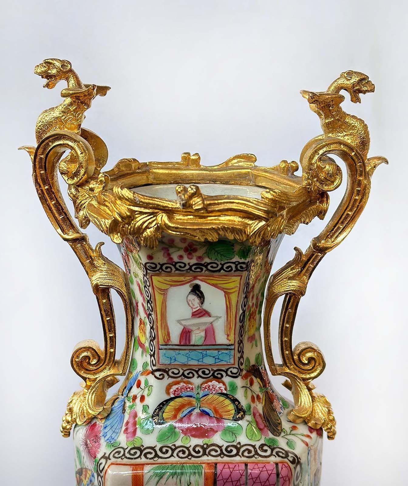 Chinese traditional Famille Rose Canton vases made with quality bronze and porcelain, having beautiful hand-painted details such as depictions of daily life, traditional Chinese scenes, botanical figures and butterflies, and the body has a unique