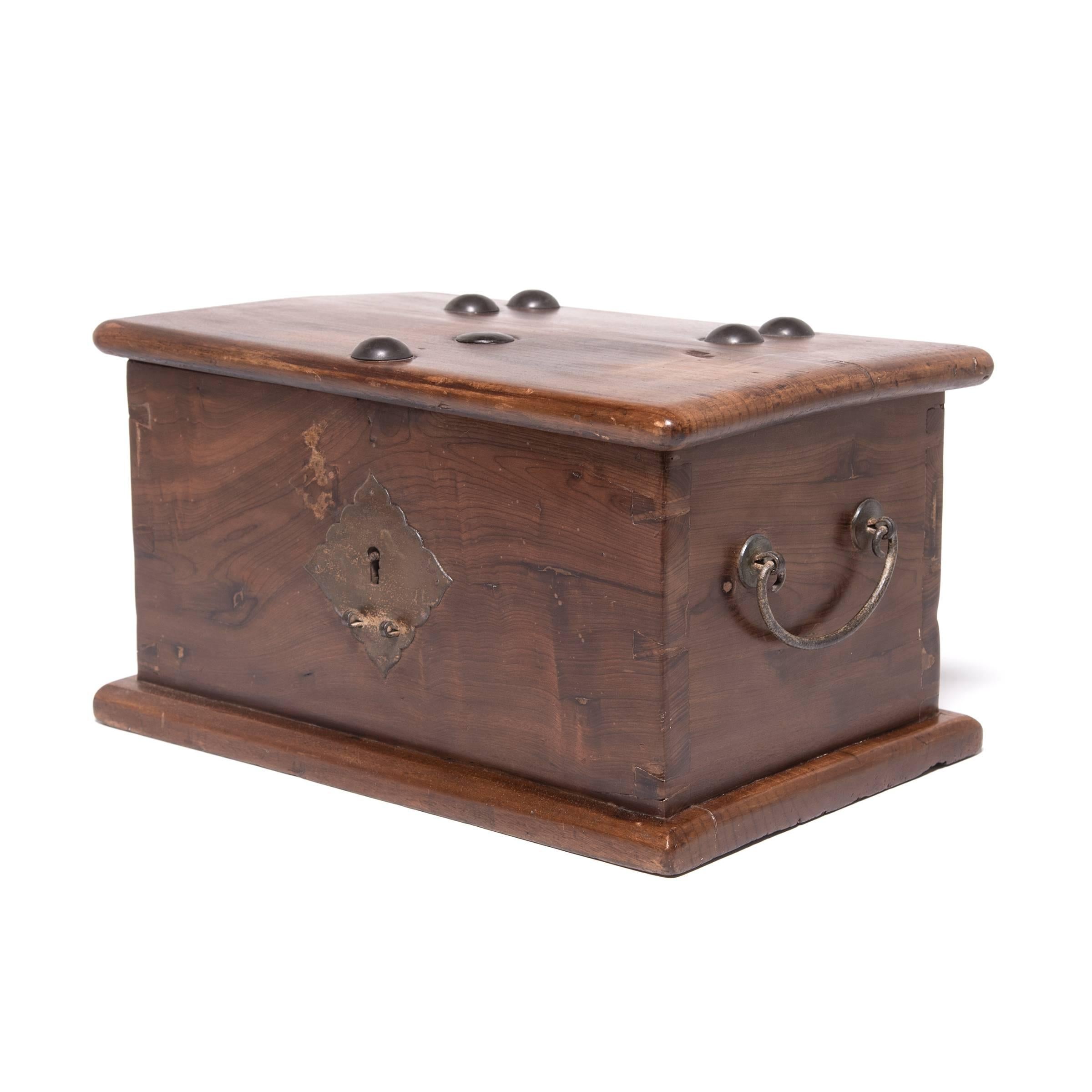 A special place for storing jewelry and other treasures, this early 19th century lock box was created by a skilled artisan in China's Jiangsu province. The box is minimally decorated to showcase the rich, swirling grain of the nanmu wood, an