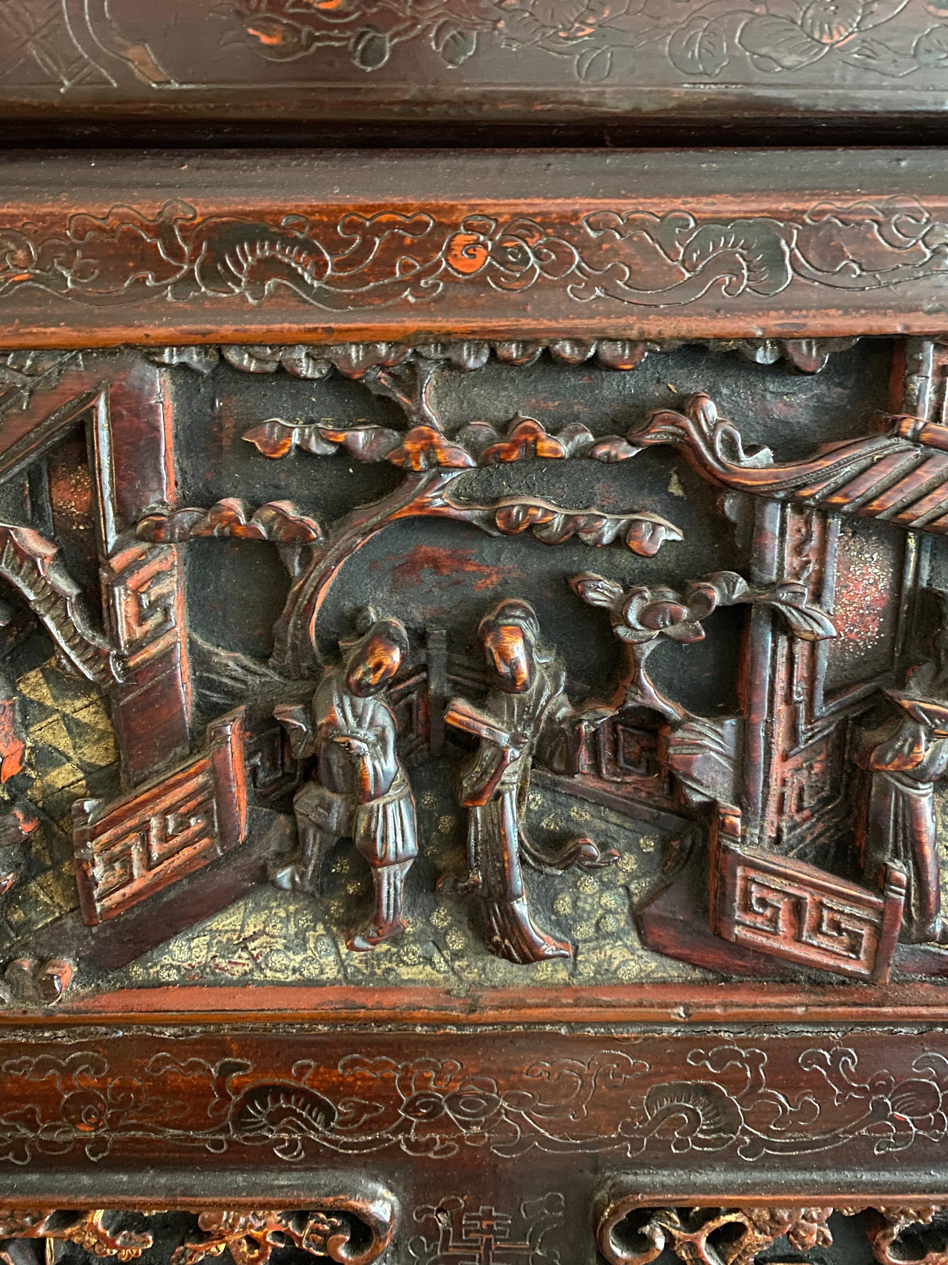 An exceptional early 19th century Chinoiserie cupboard of carved wood, gilt, lacquer and applied intricate designs. 

A delicately proportioned piece with a long horizontal cupboard at the top, a long drawer at the bottom and 2 cupboard doors