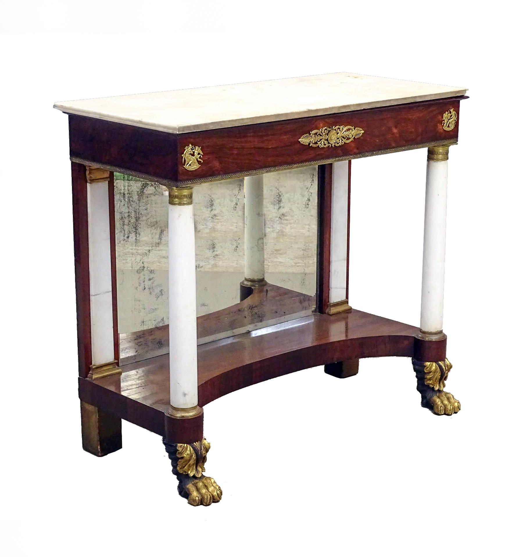 An elegant American classical pier table in rich Rosewood with Carrara marble columns and pilasters. Fine gilt bronze ormolu capitals, bases, and Roman motifs decorate the table, which retains its original marble top and mercury silver mirror. The
