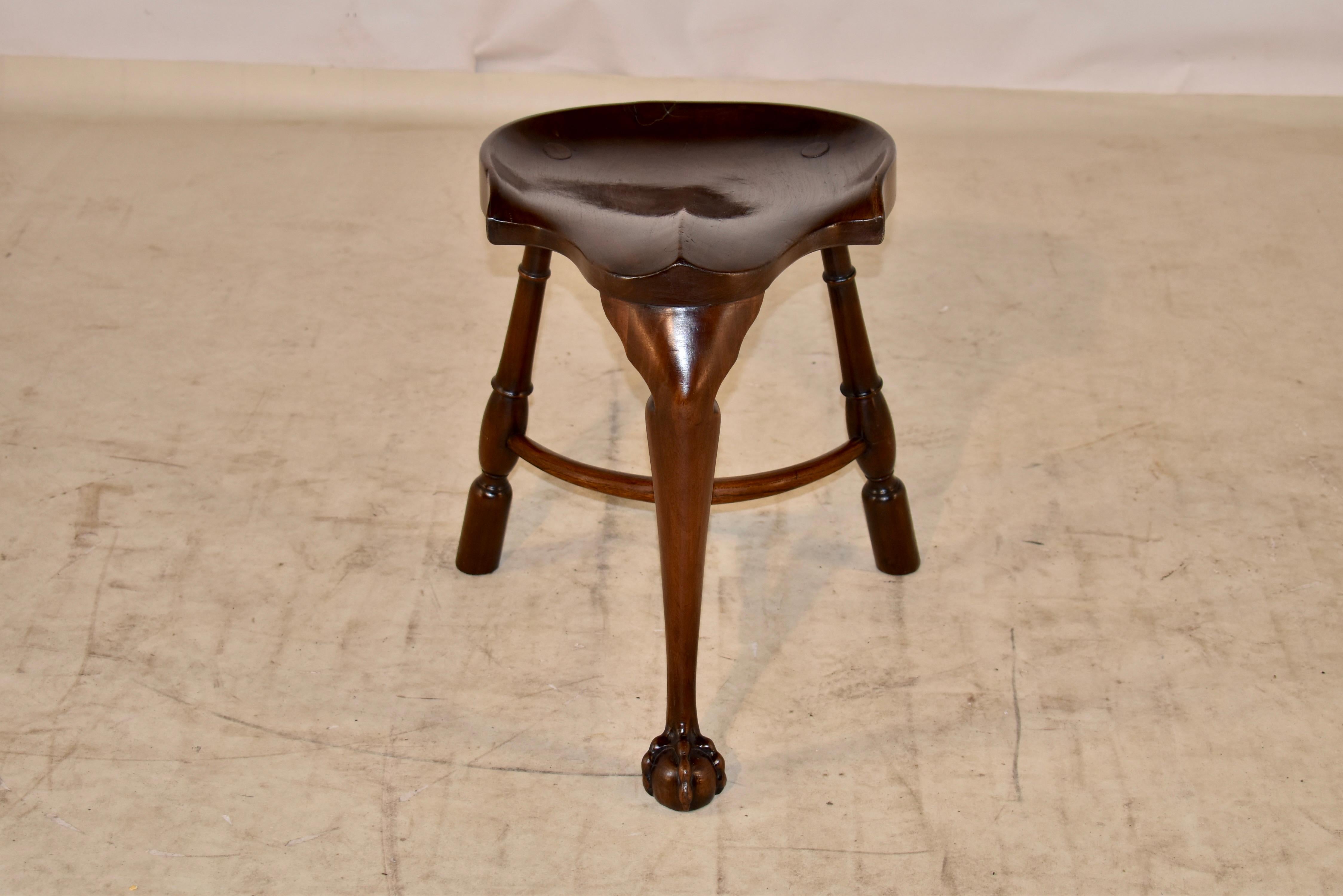 19th century mahogany and elm cock fighting stool from England. The seat is handsomely shaped from elm for comfort and aesthetic appeal. The seat is supported on three mahogany legs, which are splayed and turned in the back and in the front, the leg