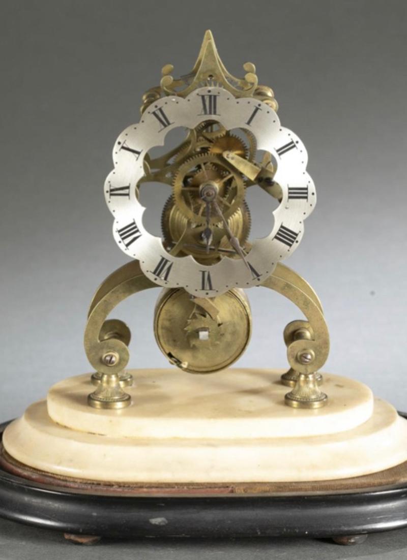 Early 19th century Continental brass skeleton clock on marble base with glass dome. Silvered chapter ring with Roman numerals. Measurements: clock - 10
