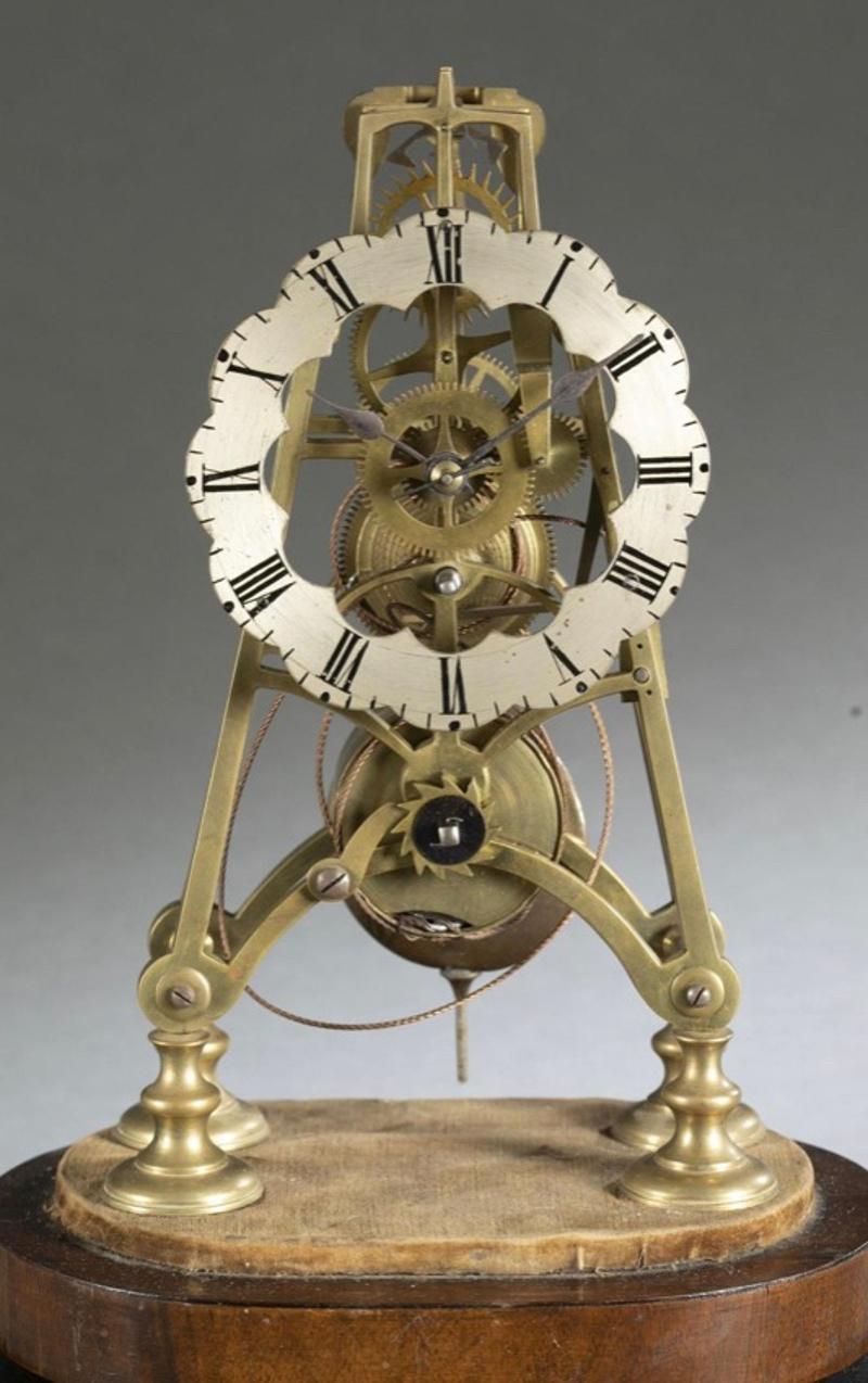 Early 19th Century Continental Brass Skeleton Clock on Wood Base with Glass Dome. Silvered chapter ring with Roman numerals. Measurements: Clock - 13