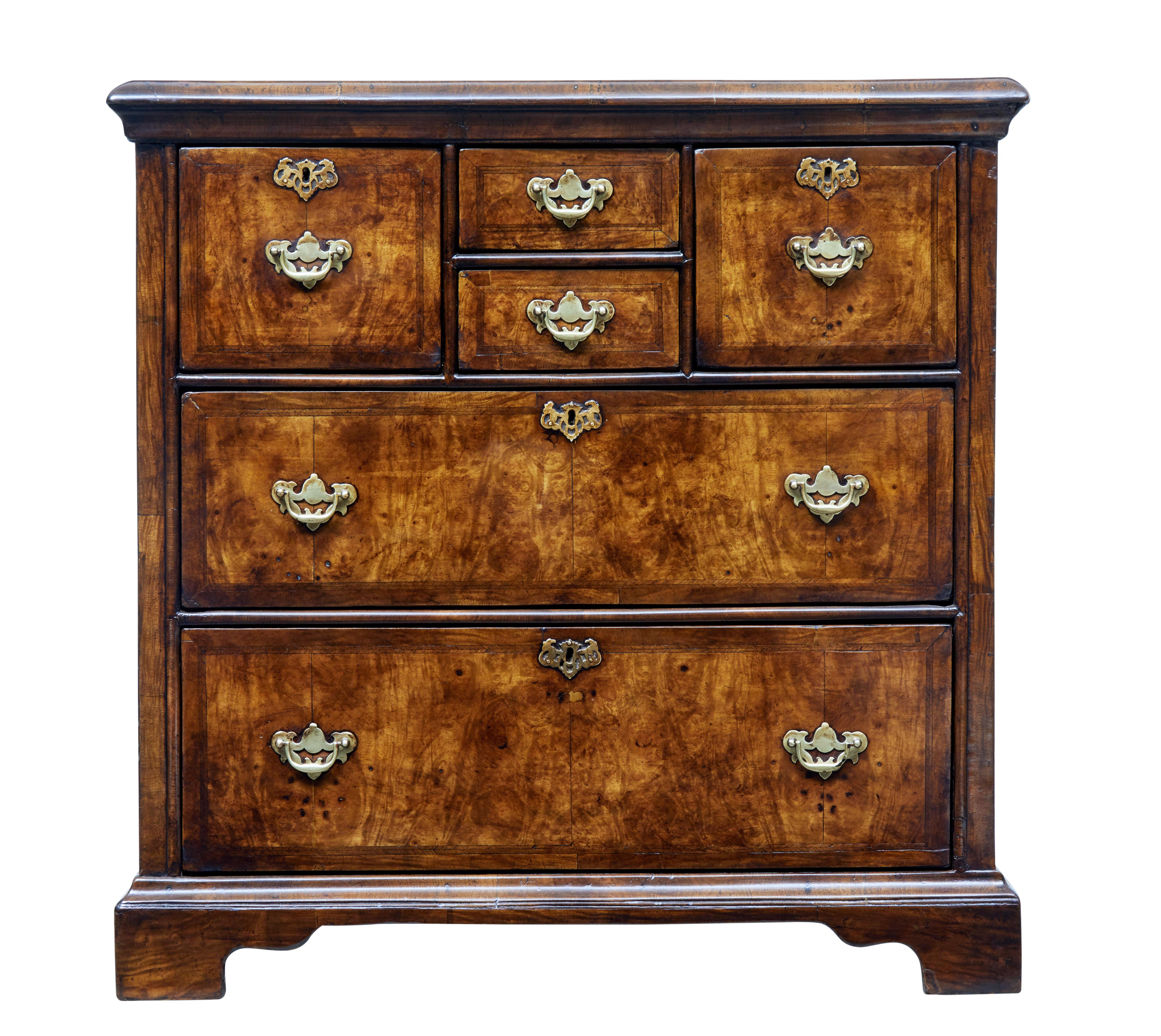 Unusual walnut chest of drawers, circa 1820.

4 smaller drawers over 2 large drawers. Fitted with brass handles and escutheons.

Drawer fronts and sides with herring bone cross banding. Top surface with a circular cross banded top design with