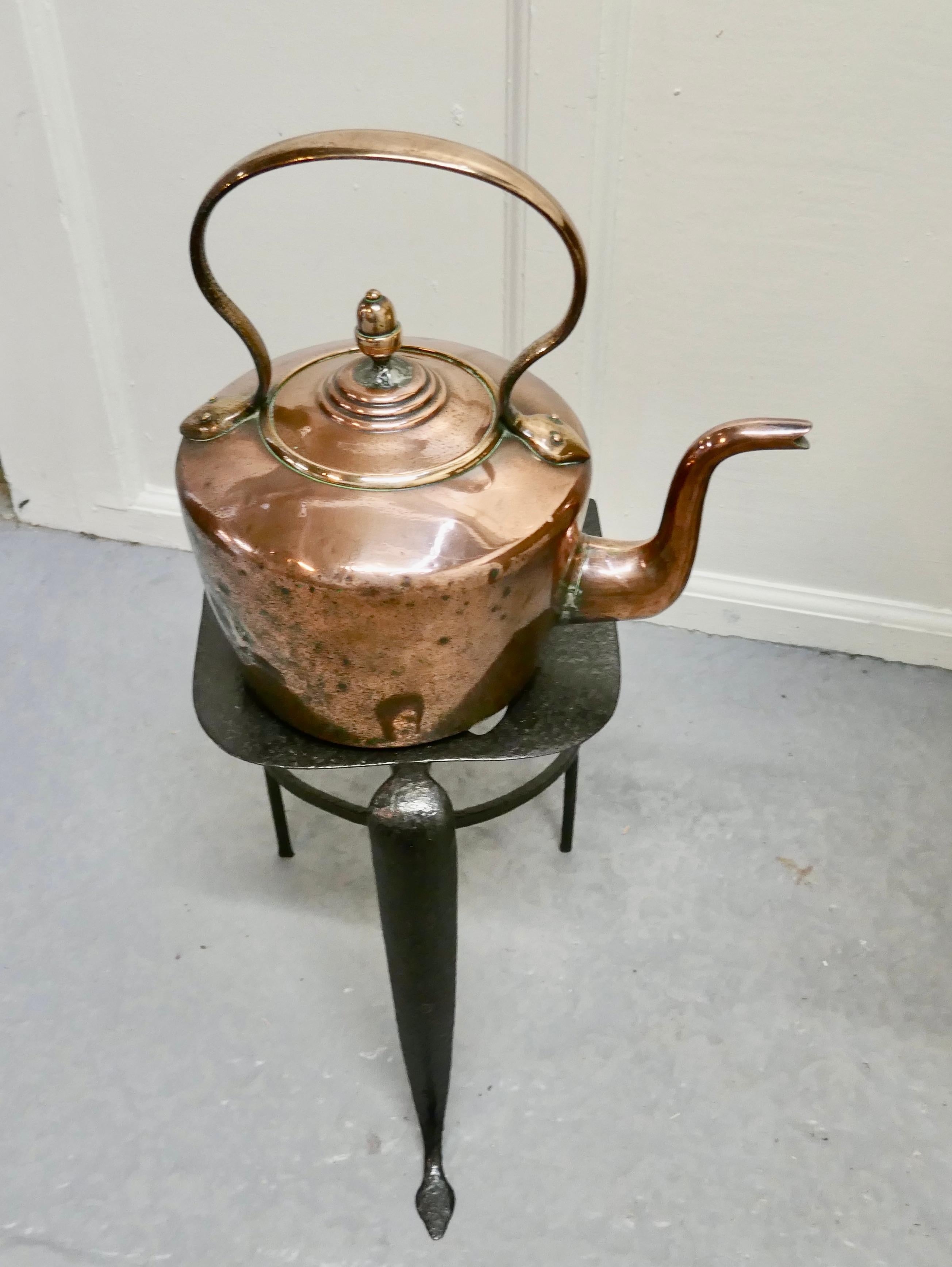 Early 19th century copper kettle and iron trivet 

A lovely traditional set, well used but sound and very attractive 

The kettle sits on an iron footman, with pierced decoration and long legs this set would look superb by an inglenook fire.
