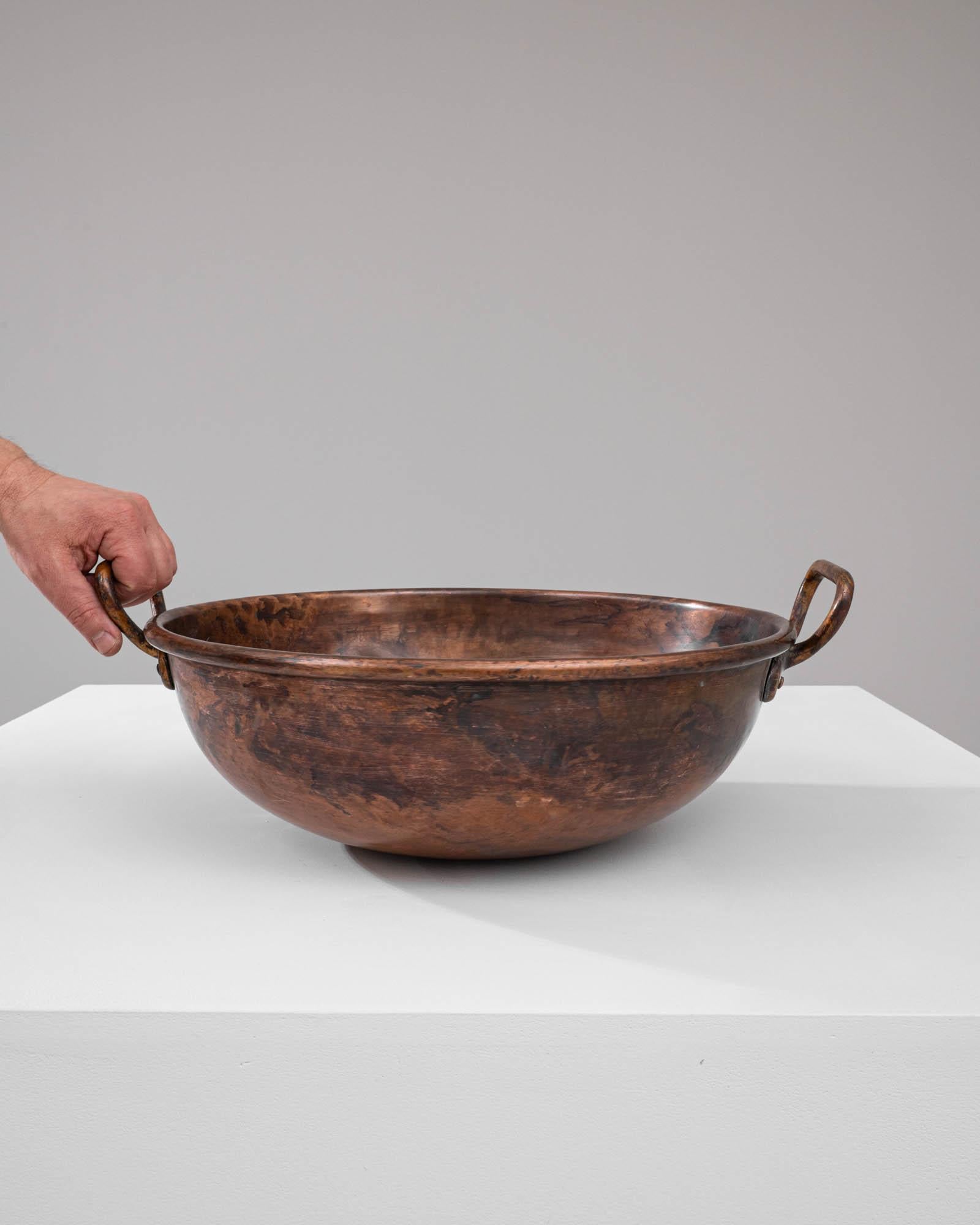 Step back in time with this authentic Early 19th Century Copper Pot, a vessel steeped in history and character. This copper cauldron, with its deep, round basin, has been handcrafted to stand the test of time, its surface worn to a rich, deep patina