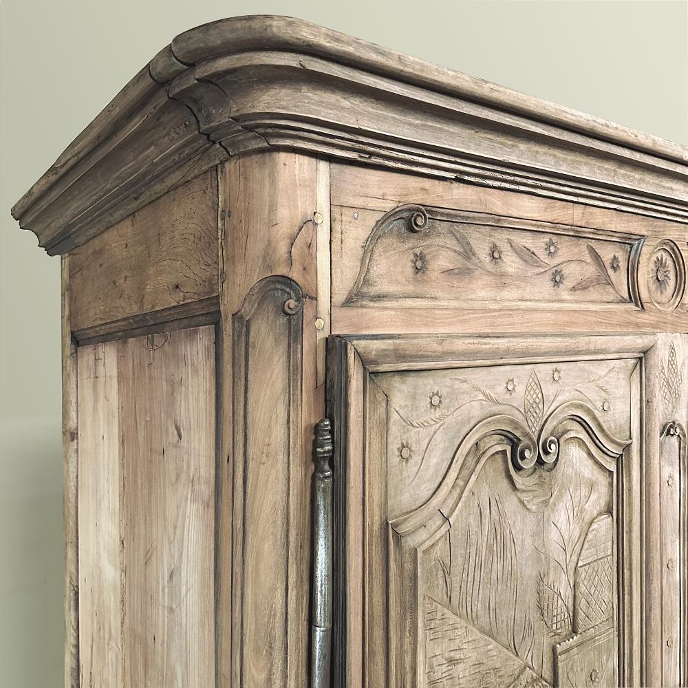 Early 19th Century Country French Armoire from Lorraine in Stripped Oak represents a remarkably early example of abstract art rendered by a rural artisan far removed from the centers of furniture craftsmanship at the time, located in Paris, Lyon and