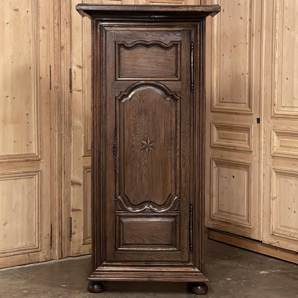 Early 19th century country French Bonnetiere is a splendid reminder of a bygone era, when cabinetry such as this was placed next to the entry most often used by family, and used to deposit outer garments immediately upon arriving home. Named after