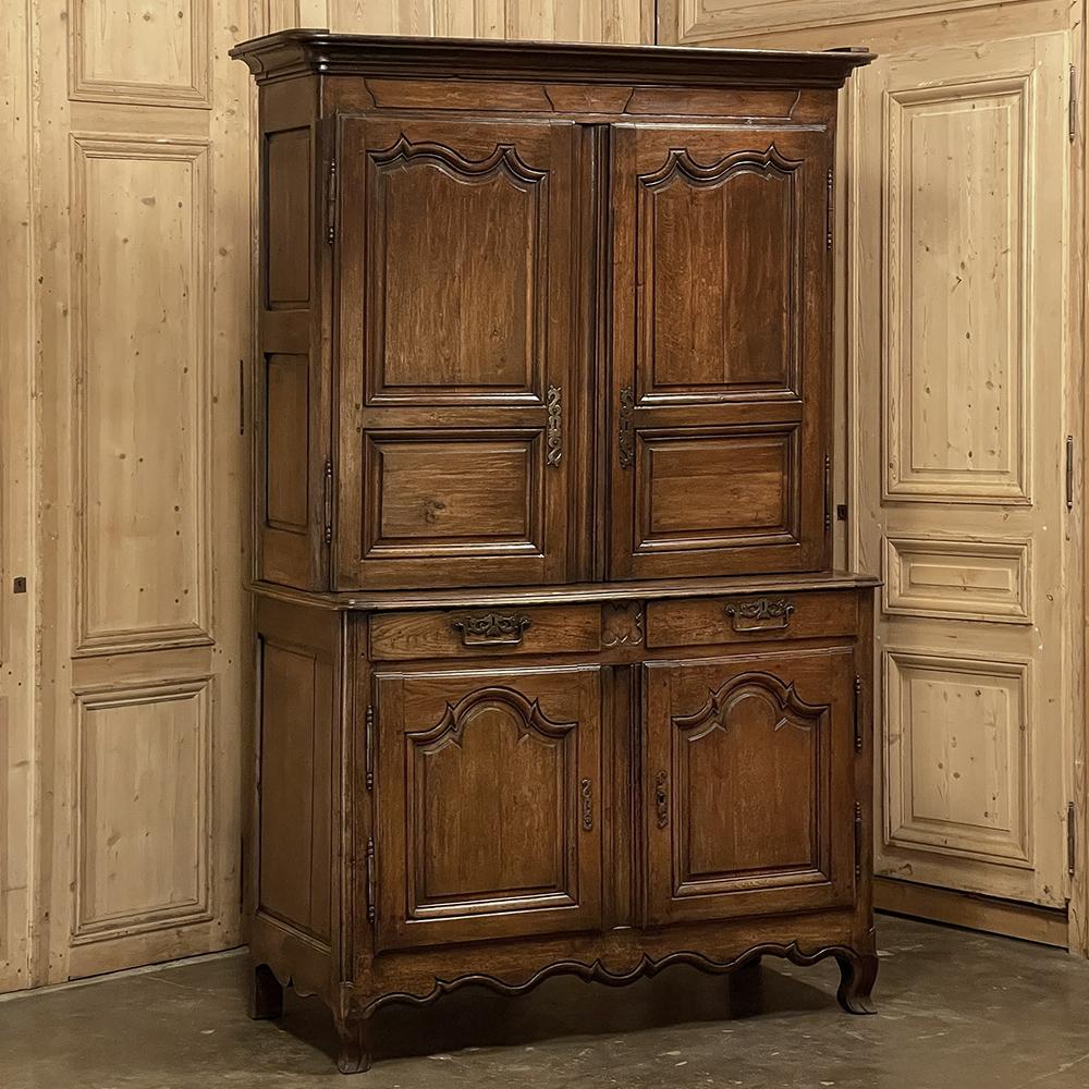 Early 19th century country French buffet a deux corps was rendered from dense, old-growth oak, and reflects the time-honored traditional craftsmanship and techniques that have been handed down through the generations. The upper tier is removable for