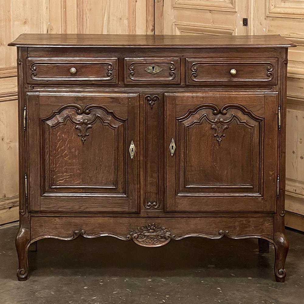 Early 19th century Country French Buffet was entirely hand-crafted from old-growth oak, and accented with brass hinges, keyguards and pulls. Look closely to see the pegged mortise & tenon joinery, a technique centuries old that has been handed down