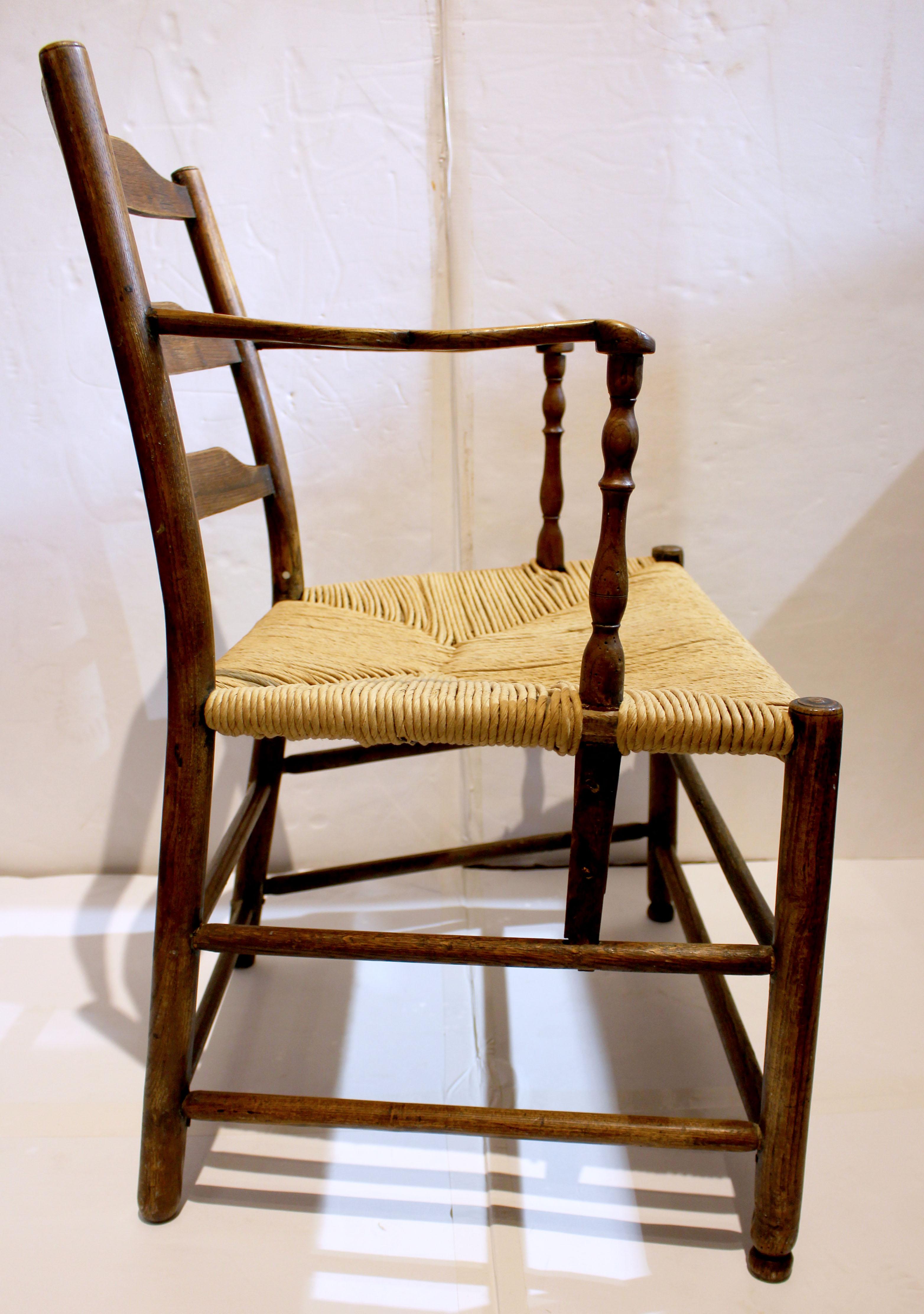 Early 19th century country French ladder-back arm chair. Robust form, graduated ladder-back rails with charming returns & shaping of the arms. Vasiform arm supports. Turned legs & stretchers. Made of ash wood, with old rush seat.
23.5