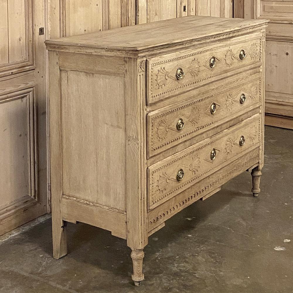 Early 19th century Country French Louis XVI stripped oak commode is a marvel of craftsmanship, all rendered in solid indigenous old-growth oak to last for generations! The neoclassic-inspired architecture features a simply molded side panel with a
