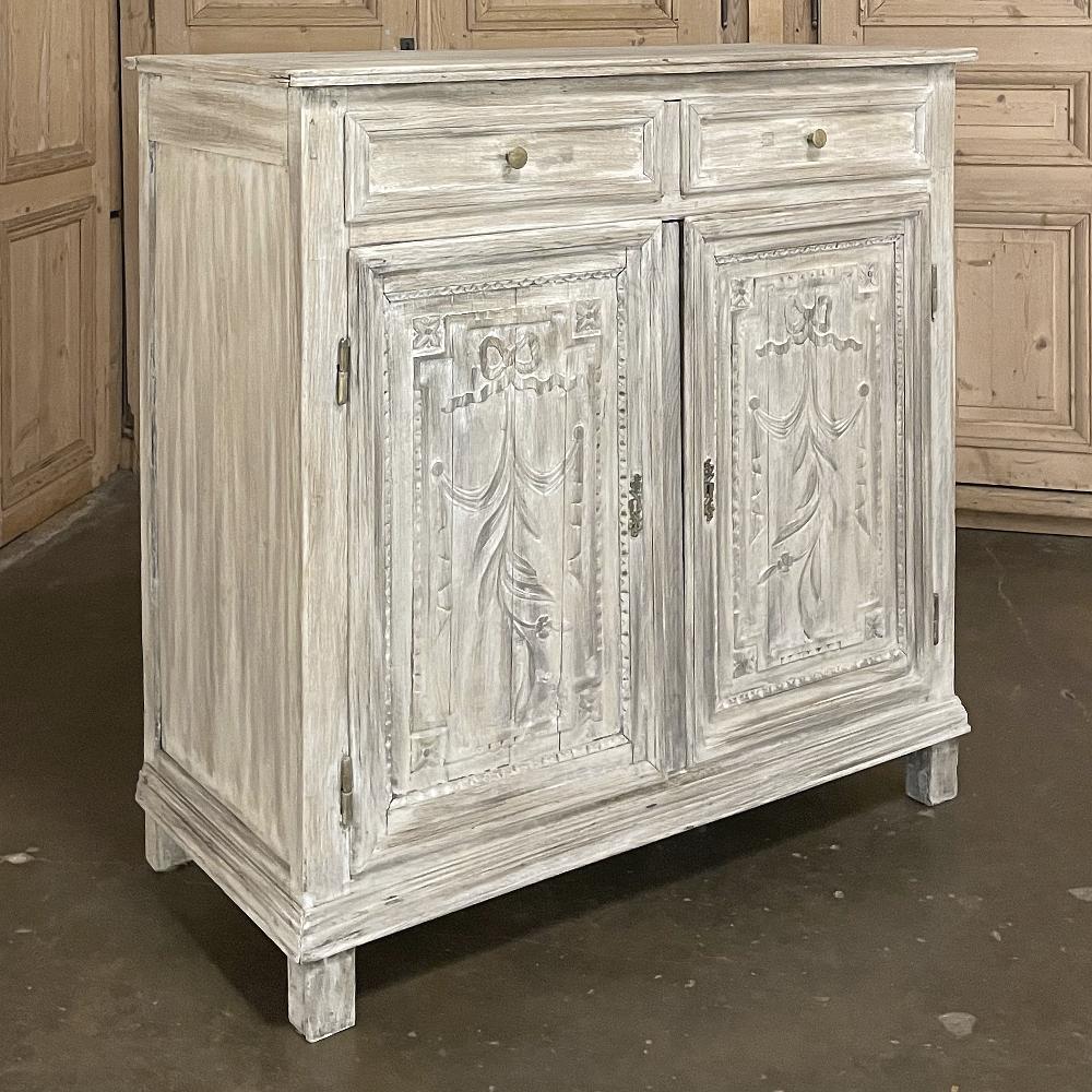 Early 19th century country French Louis XVI whitewashed oak buffet was designed to maximize storage while providing a minimal footprint on the floor plan. Tailored neoclassical architecture is enhanced by subtle molded detail and brilliant bas