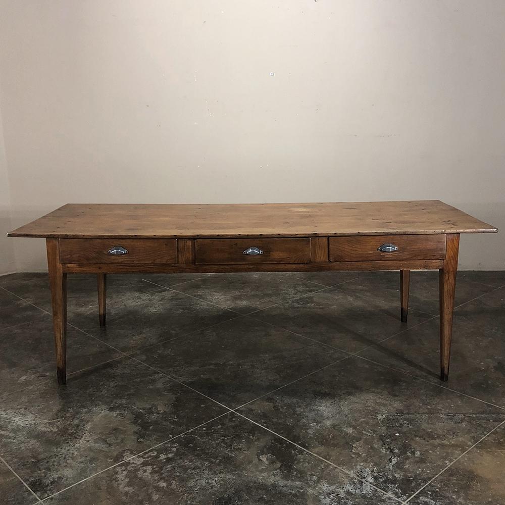 Early 19th century Country French pine farm table represents the essence of simplicity and functionality - handcrafted by rural artisans who had other things to do around the farm! A bit wider than most, it will comfortably seat eight and maybe even