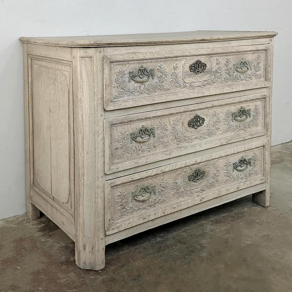Early 19th century country French stripped commode is a great size for virtually all rooms, providing a nice surface and three spacious drawers in splendid Provincial style! A neoclassical theme appears in bas relief across the drawer facades with