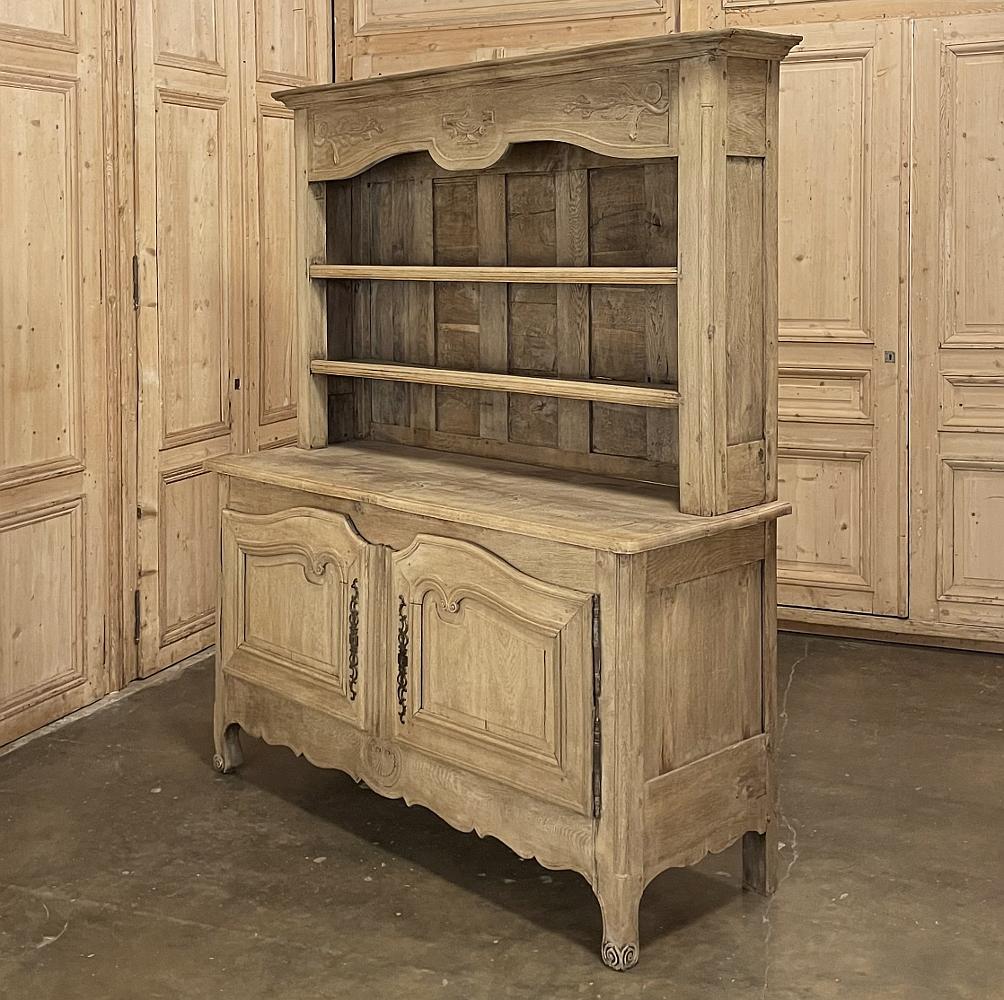 Early 19th century country French Vaisselier ~ Buffet in Stripped Oak is a marvelous example of fine rural artisanry, with special attention paid to the joinery and carved details normally not found in such a piece. The bold crown is enhanced by the