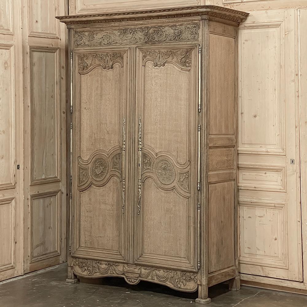 Early 19th Century Country French Wedding Armoire from Normandie in Stripped Oak is a magnificent example of hand-crafted and artistically sculpted furniture!  Crafted from dense, old-growth indigenous oak, it features the classic motifs and