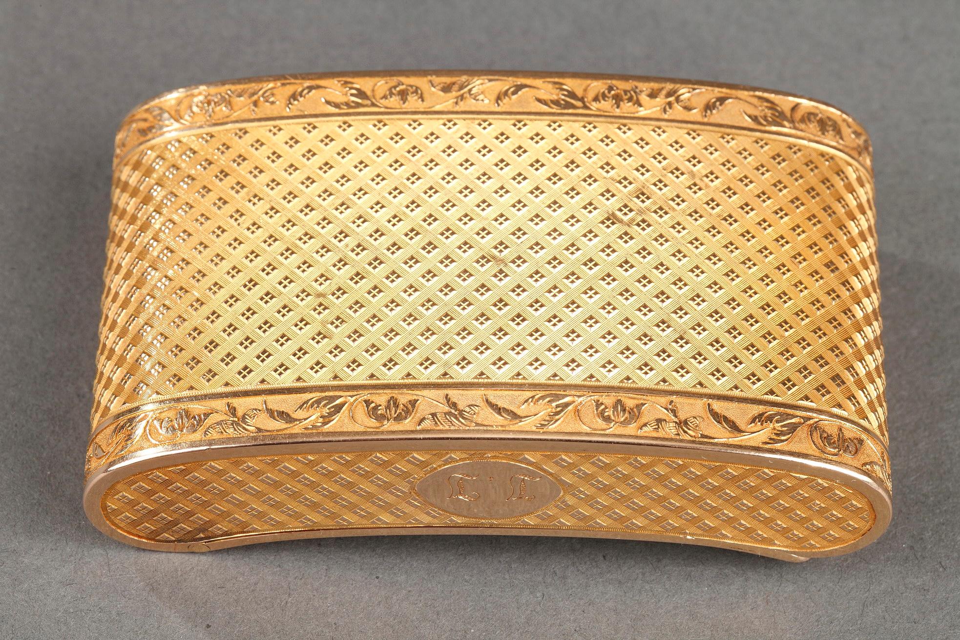 A rectangular snuff box with rounded corners. The box is lightly curved, allowing it to fit comfortably into a pocket. The box is entirely covered with intricately sculpted geometric patterns. Each panel of the box is framed in a frieze of rinceau