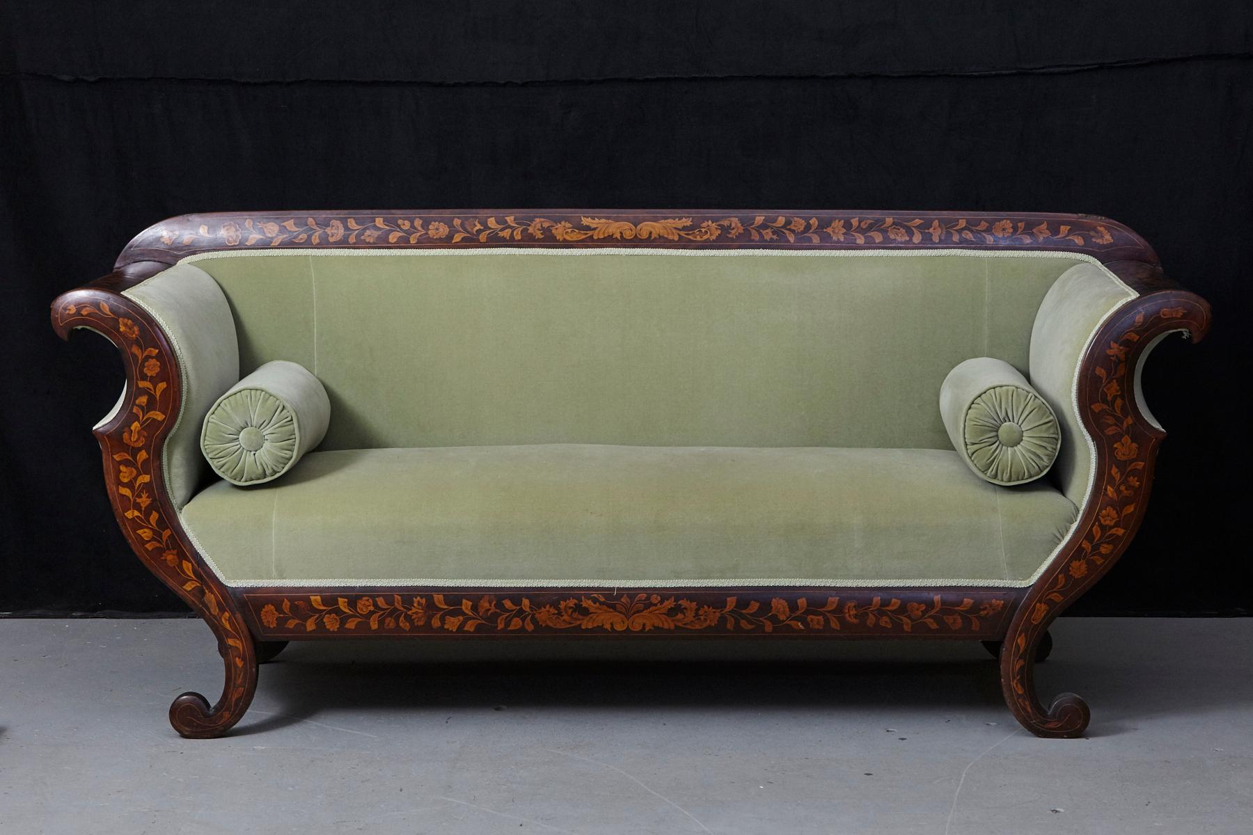 Lovely early 19th century Dutch Biedermeier carved fruitwood three seat sofa with intricate veneered marquetry in decorative floral patterns and lime green velvet upholstery.
The upholstery is still in good condition and seating is firm, a few