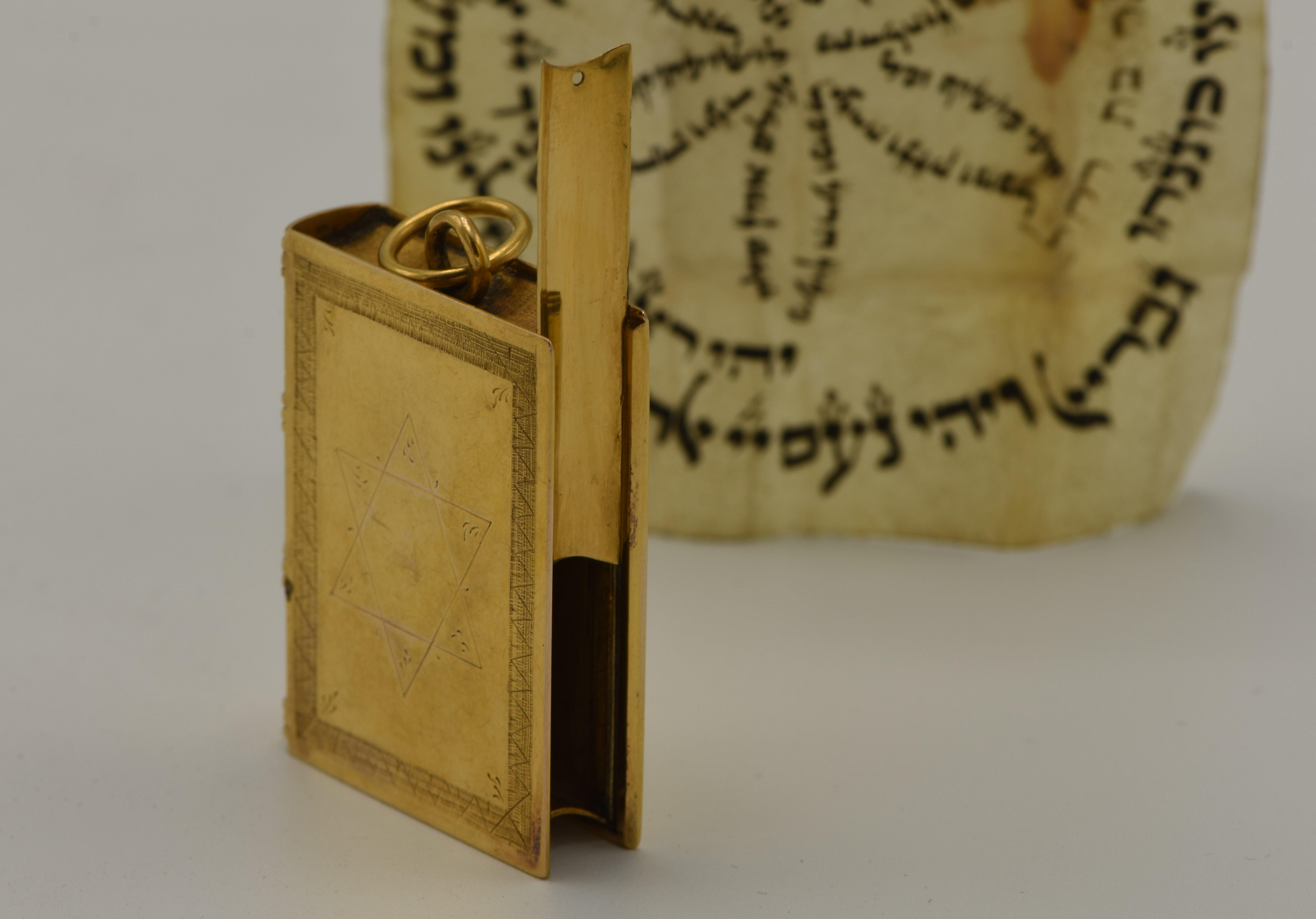 Unique and rare gold Amulet case with the original parchment, the Netherlands, circa 1800.
Solid gold case, book-form, highly detailed with bolt spine. Engraved on the front with Star of David, surrounded by rectangular frame, and on the back with