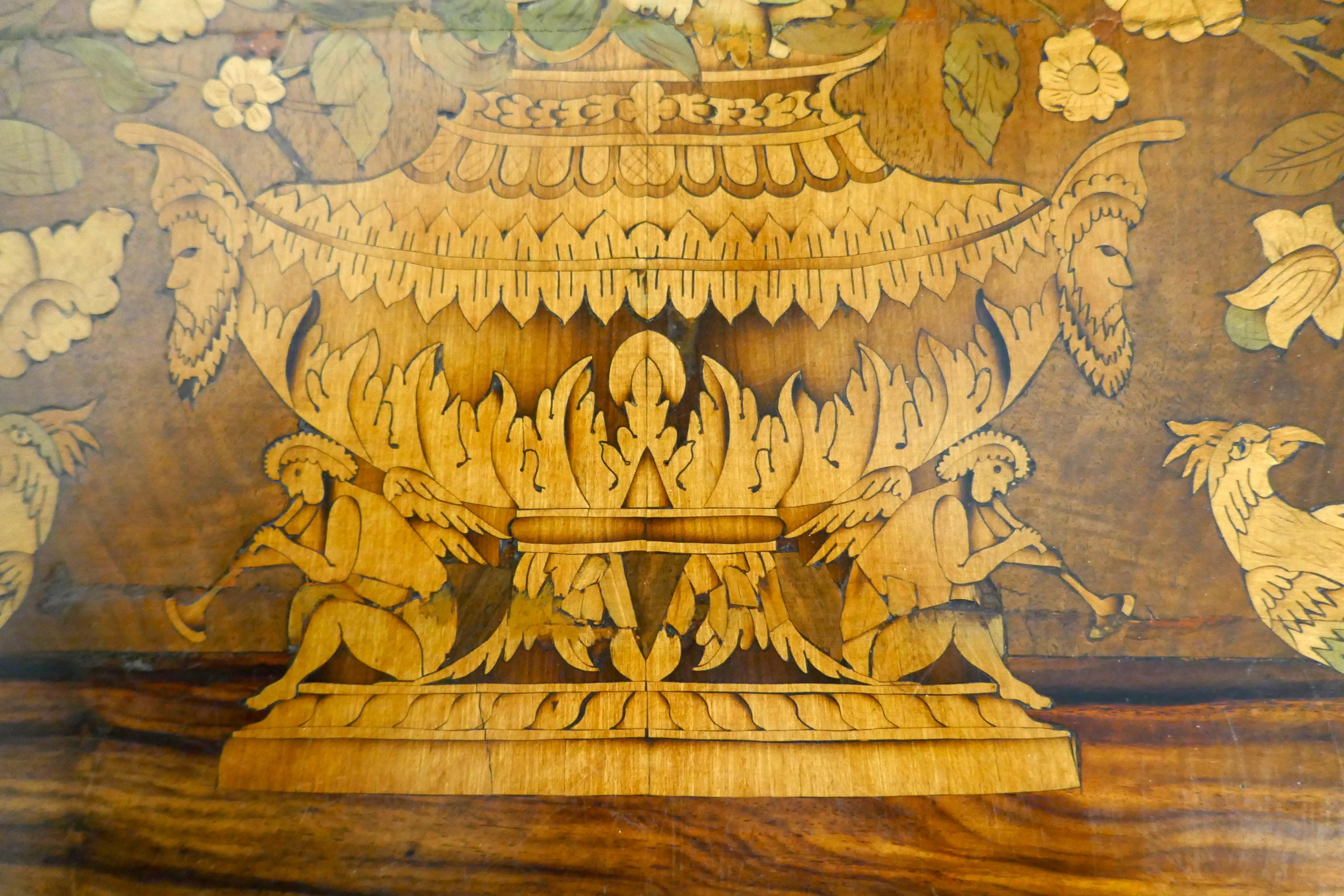 Early 19th century Dutch marquetry inlaid walnut centre table

This is a rectangular table with a marquetry design on the top and a drawer on one side, the legs are tapering with flat sides these are inlaid, as is the X-shaped stretcher. The under