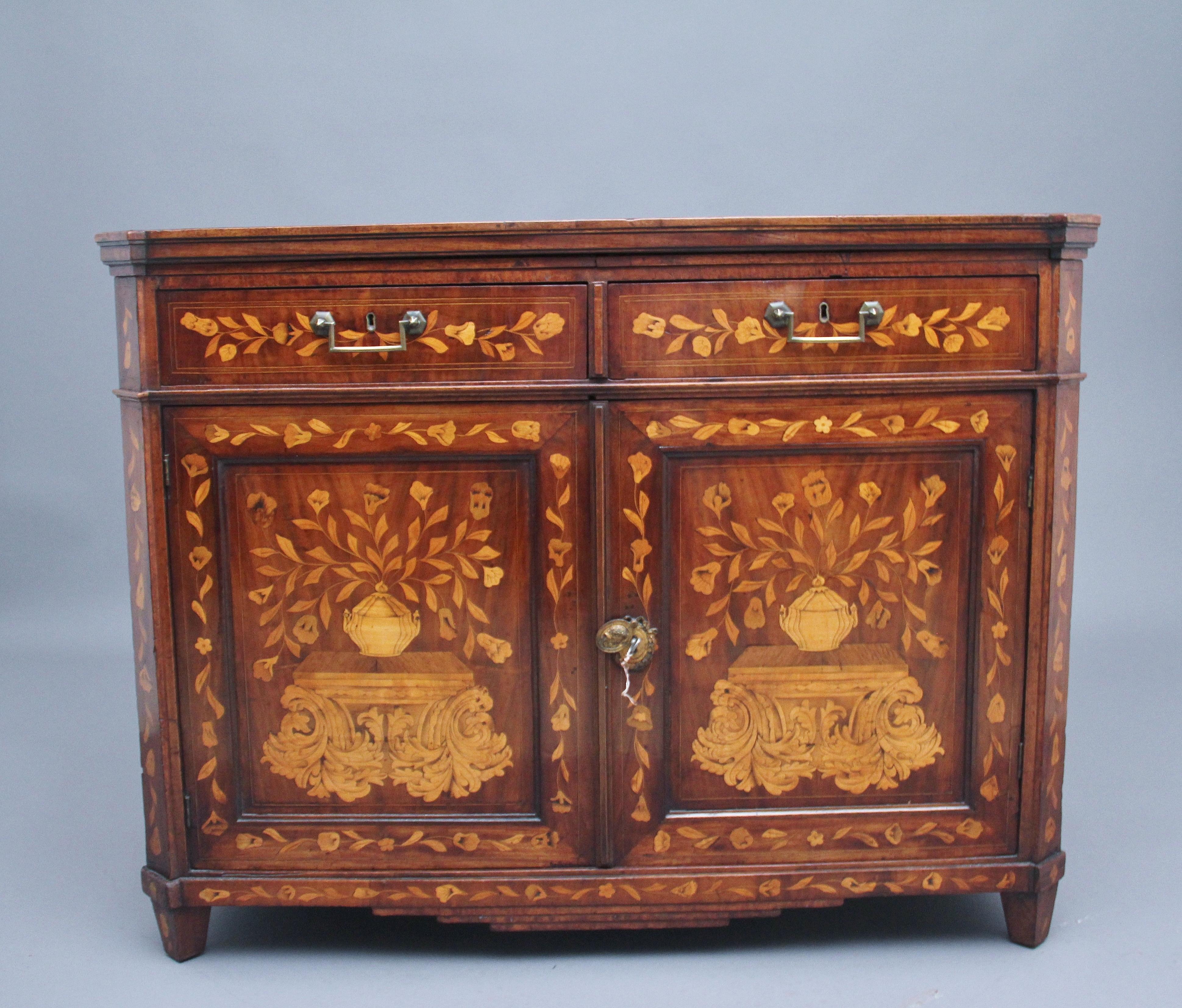 A lovely quality early 19th Century Dutch marquetry travelling cabinet, profusely inlaid all over with various foliage and urns, the decorative top depicting a countryside scene, which lifts up to reveal folding shelves and back panel, the faux