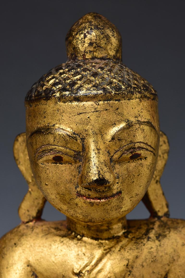 Burmese wooden Buddha sitting in Mara Vijaya (calling the earth to witness) posture on a base.

Age: Burma, Early Mandalay period, Early 19th century
Size: Height 36.4 C.M. / Width 18.5 C.M.
Condition: Nice condition overall (some expected