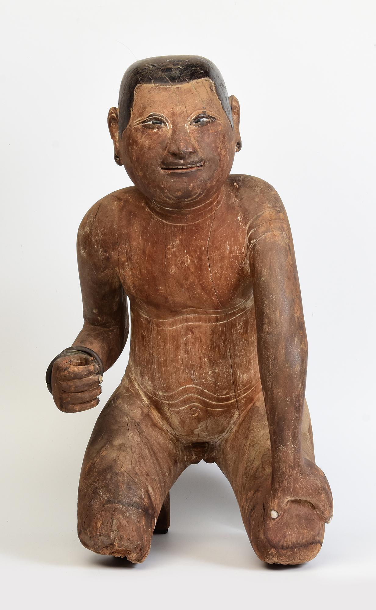 Antique Burmese wooden sitting boy.

Age: Burma, Early Mandalay Period, Early 19th Century
Size: Height 54 C.M. / Width 31 C.M.
Condition: Nice condition overall (some expected degradation due to its age).

100% satisfaction and authenticity