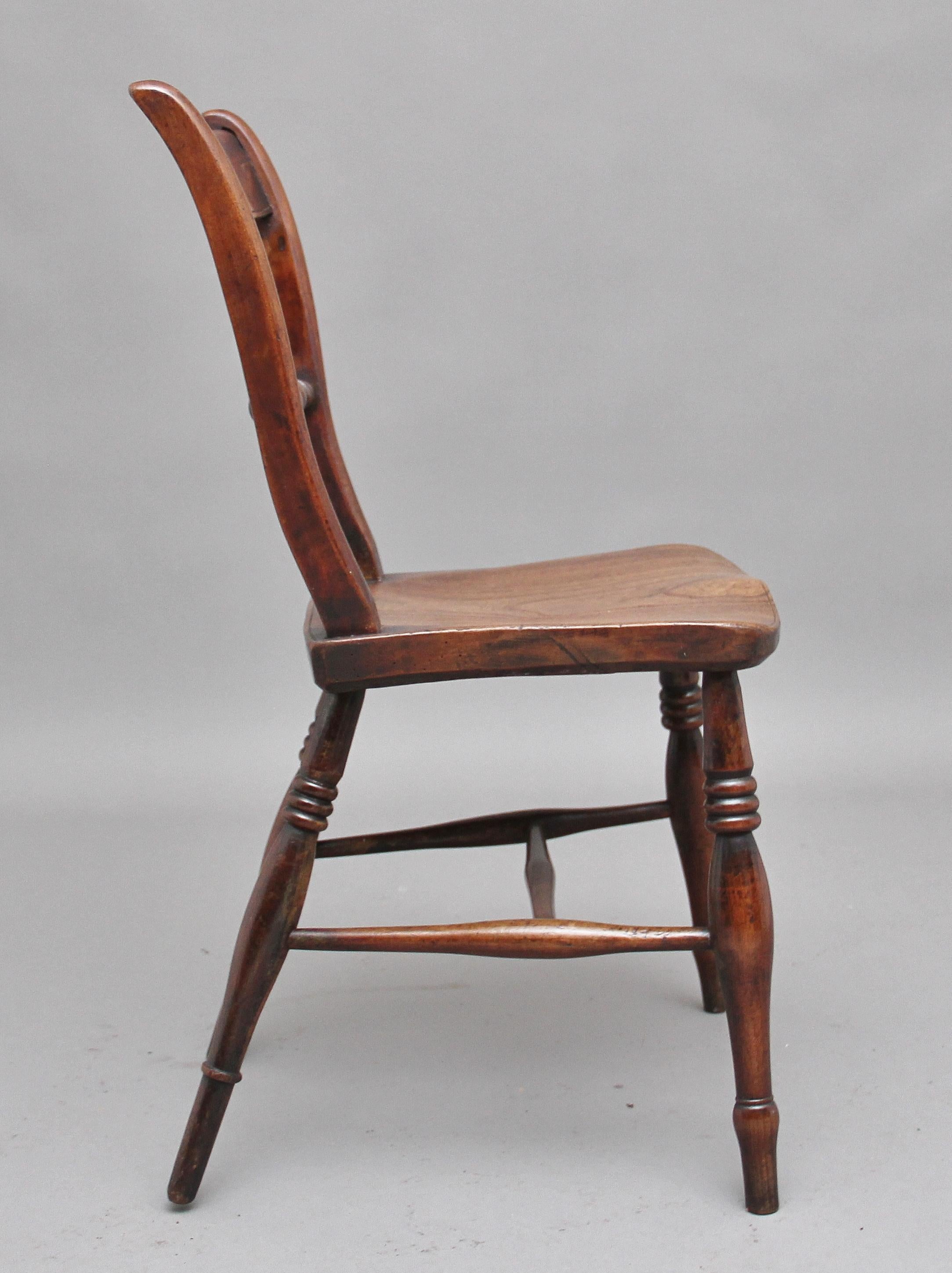 Early 19th century elm and ash side chair, the bar back supported by a turned spindle, a nice figured saddle seat, standing on turned legs united by an H stretcher, circa 1840.
  