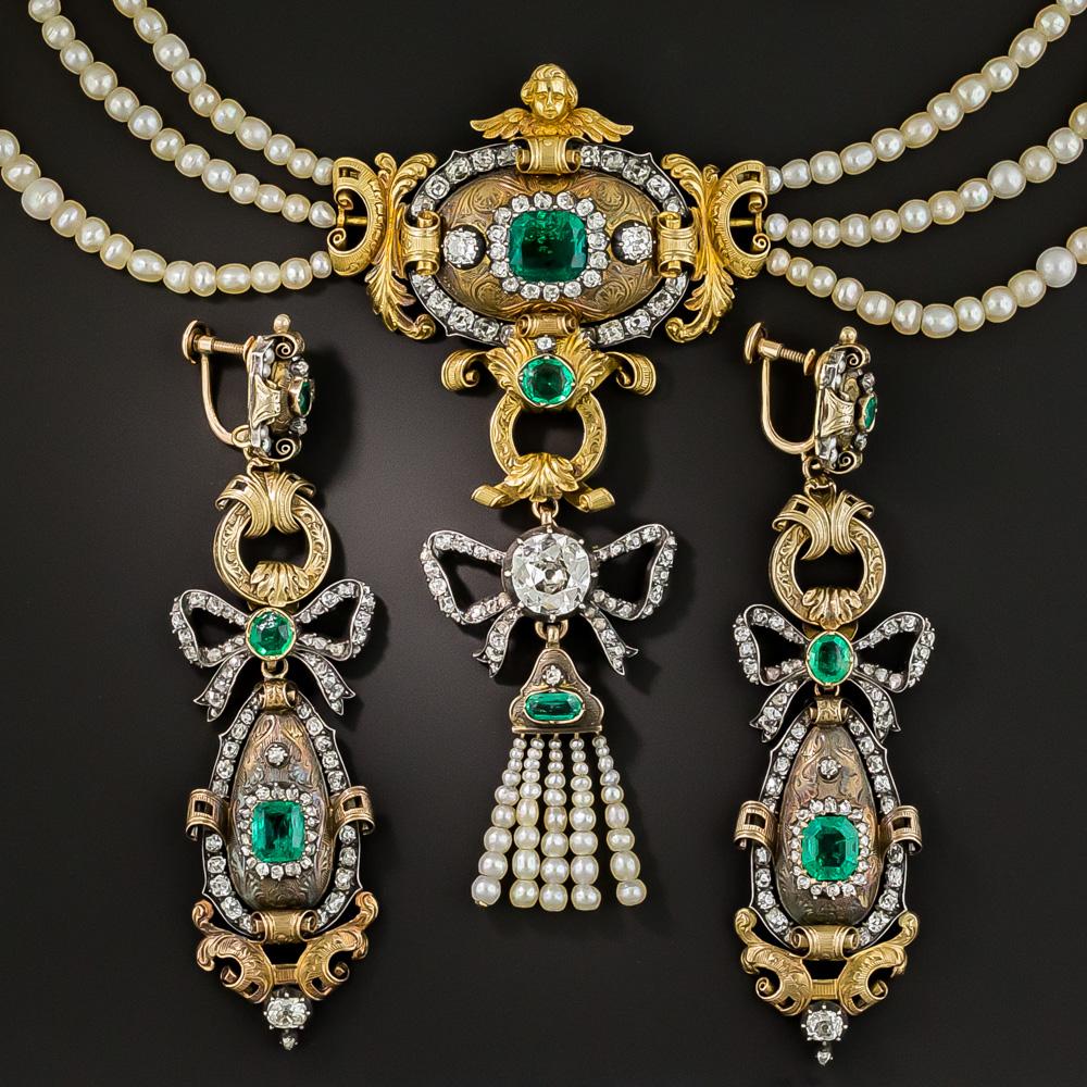 Convincingly reputed to be formerly part of the Spanish Crown Jewels, in the story passed to us, this impressive museum quality ensemble could have been plucked right from a royal palace painting. The three and one-half inch long centerpiece