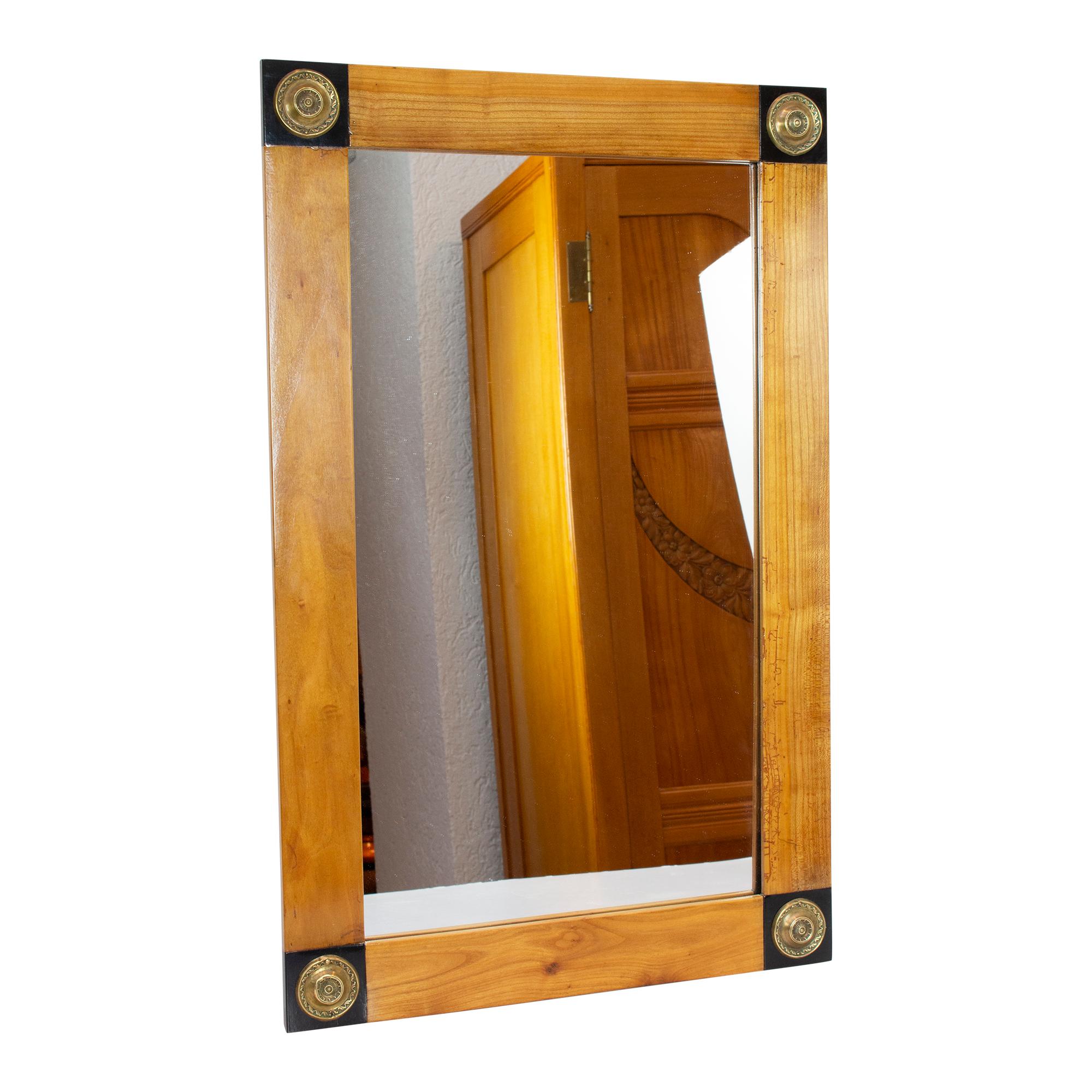 Mirror from the time circa 1810, from period of Empire / Biedermeier, made of cherrywood deposed with ebonised elements in the corner with brass fittings. The mirror glass was renewed sometime in the course of time.
Very good restored condition.