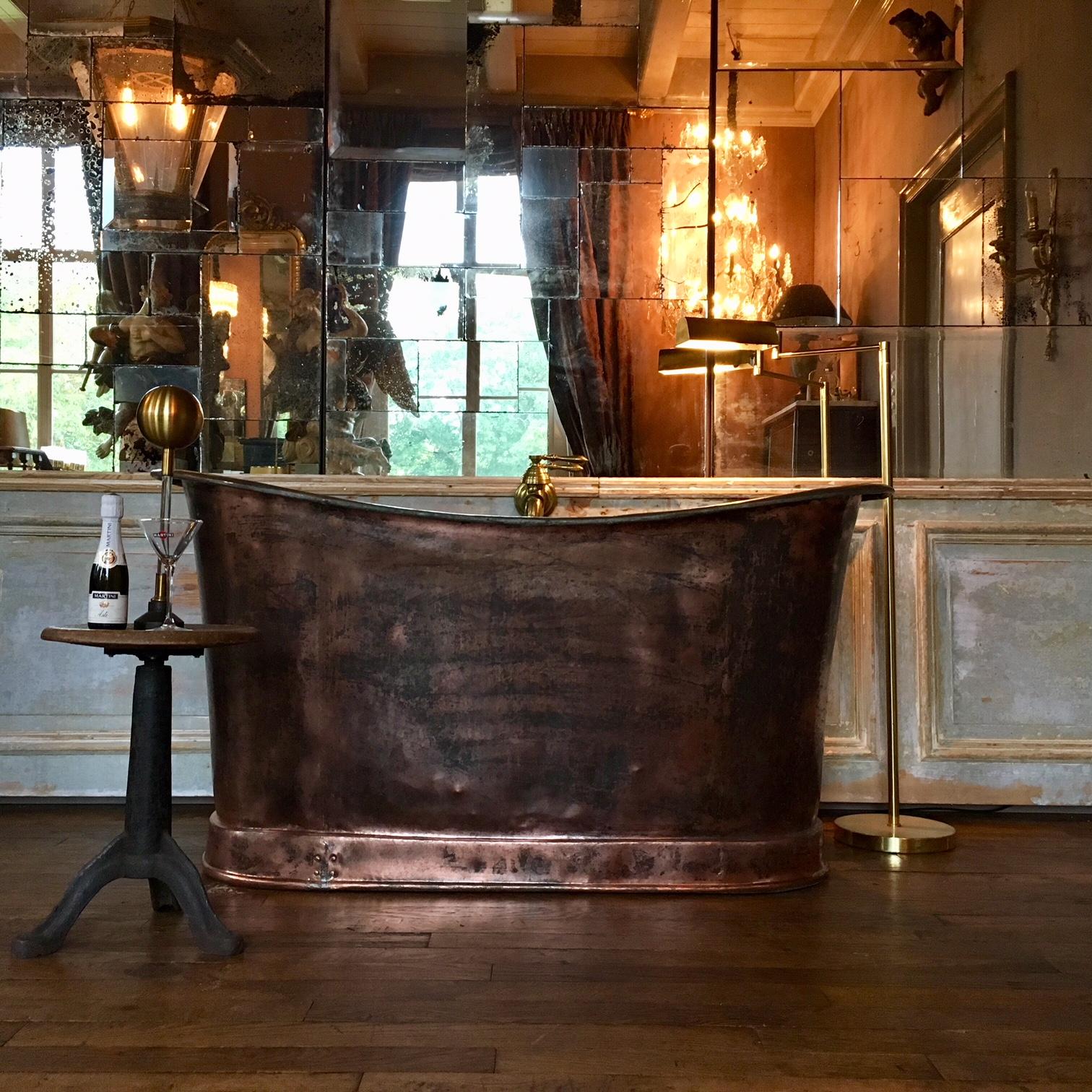 Beautiful copper tub made in the early 19th century. In this model tub you have to bathe sitting, that is why the tub is very high. The copper has been polished in a rough manner to create a beautiful stained effect. The drain is placed in the