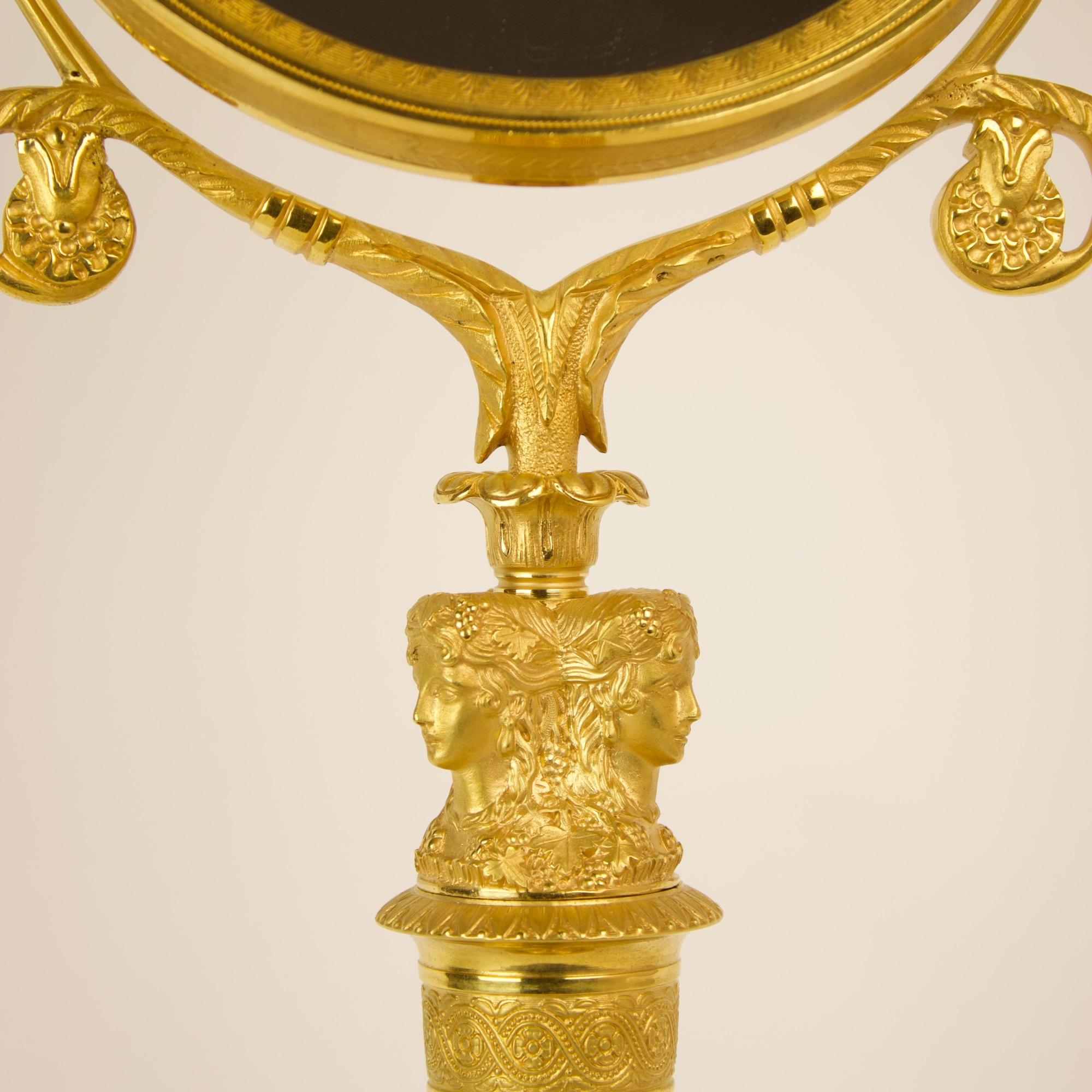 Early 19th century Empire Female Bacchantes caryatids gilt bronze table mirror.

A rare and beautiful Empire gilt-bronze table mirror, a so-called 