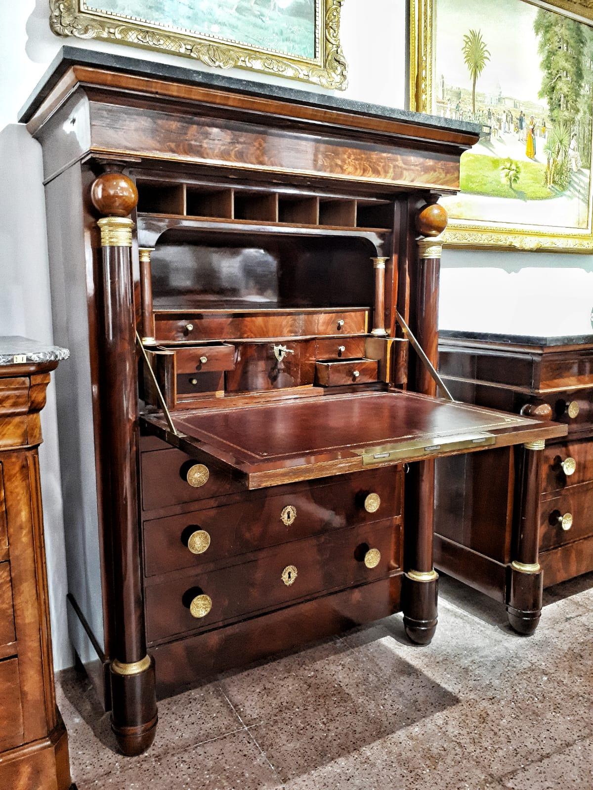 Wonderful French empire secretaire, early 19th century. Flame mahogany, Belgian black marble, leather, bronze details, with two working keys and two secret drawers.

Secretaire of excellent quality, made of mahogany wood adorned with bronze, with