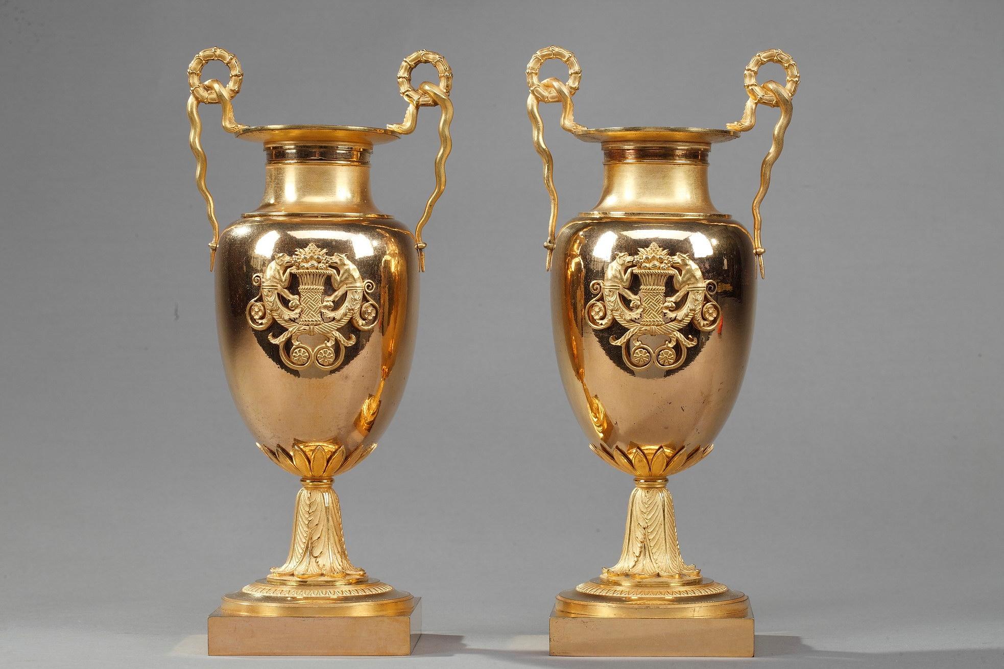 Pair of small krater centerpiece vases crafted entirely from ormolu bronze. A krater was a large vase in Ancient Greece, particularly used for watering down wine. These antique vases feature delicately snake-shaped handles. The paunch is beautifully