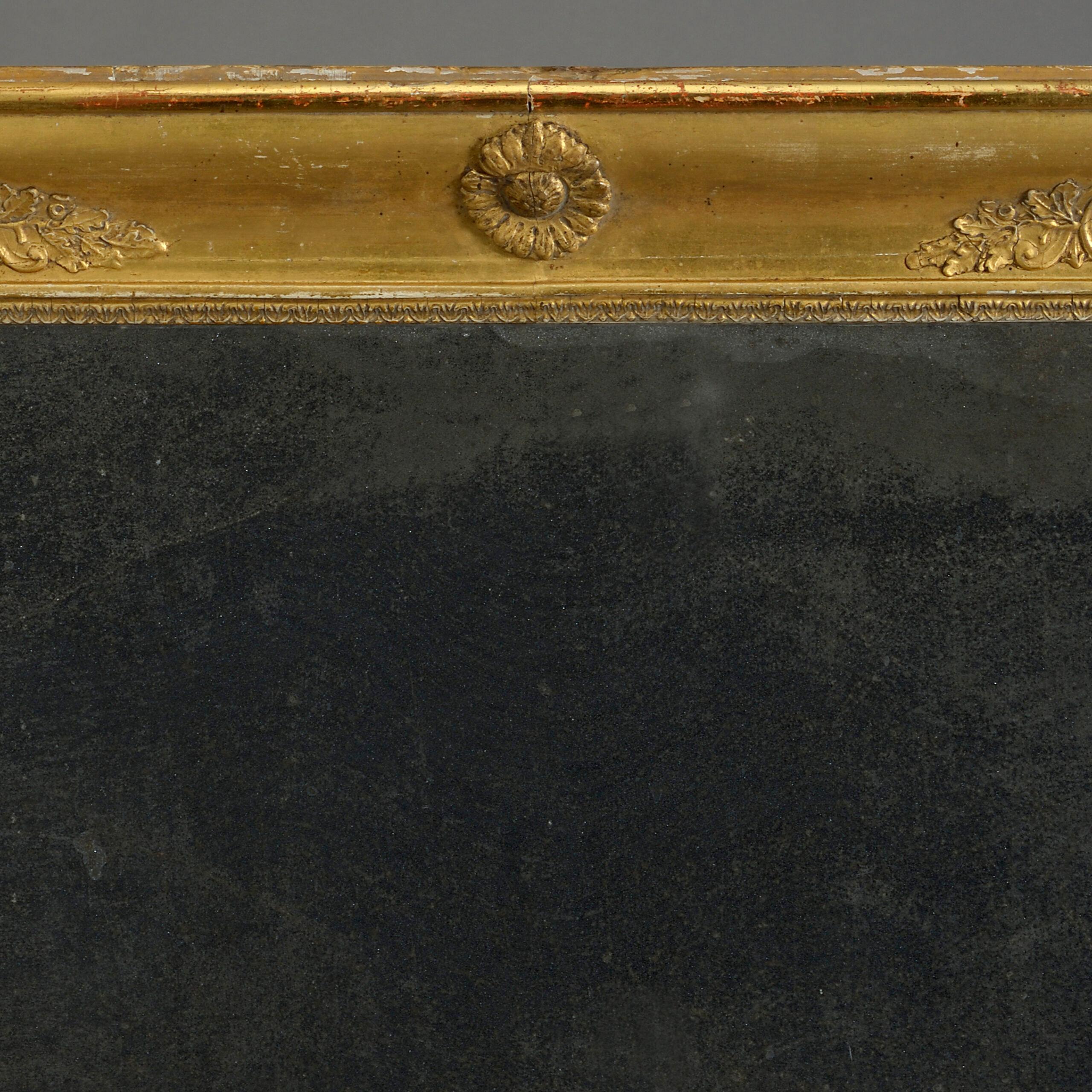 An early nineteenth century Empire Period giltwood mirror, the frame with applied classical decoration and housing the original mercury plate.

Circa 1820, France.

Dimensions: 26 W x 2 D x 40.25 H inches.
66 W x 5 D x 102.25 H cm.