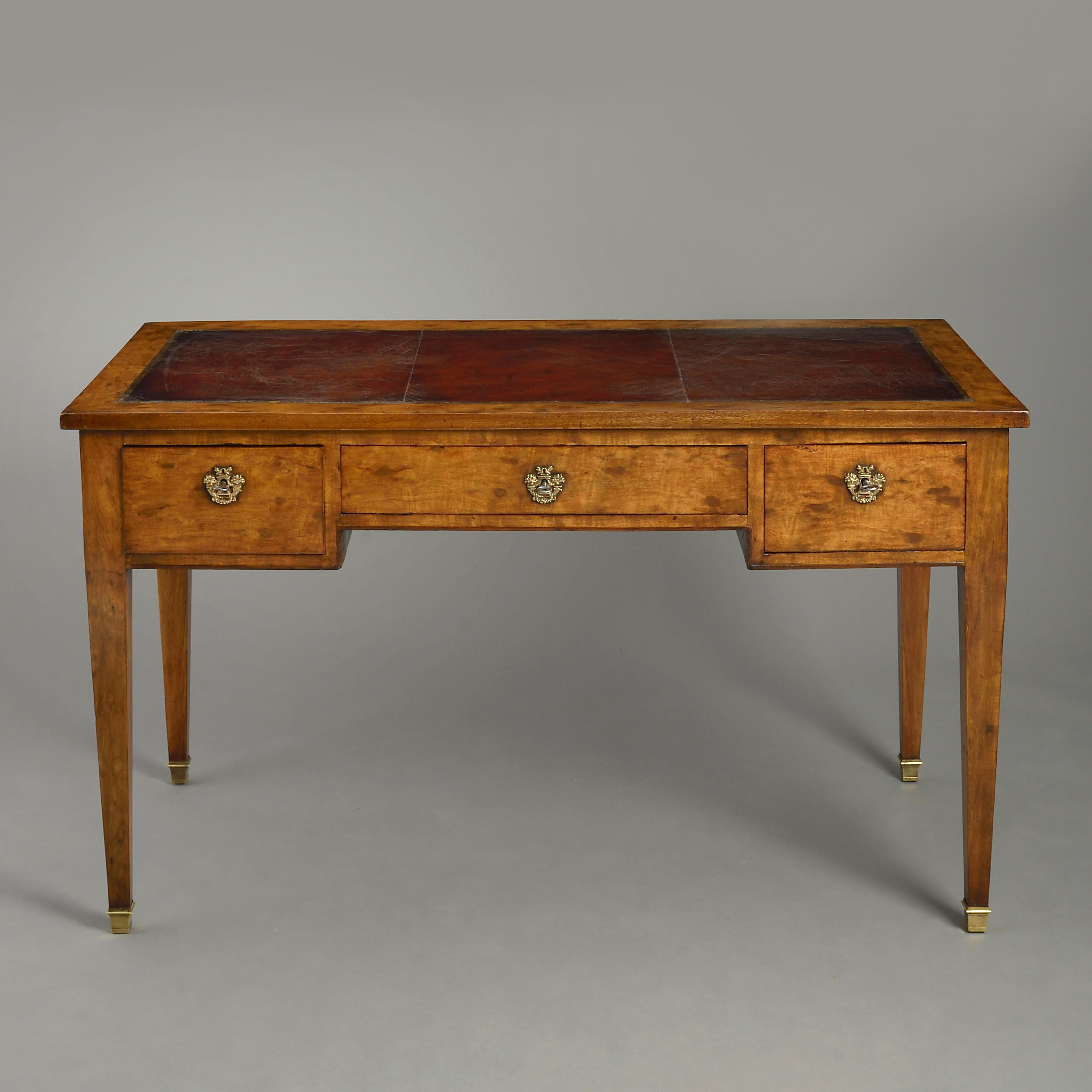 An early 19th century plum pudding mahogany bureau plat, having a leather top above a central long drawer and two flanking drawers, all raised on square tapering legs with brass sabots.

   