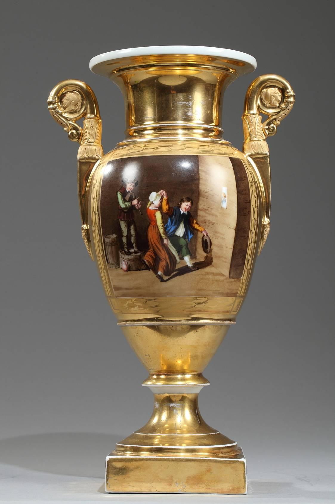 Early 19th century porcelain baluster-shaped vases set upon a high foot and a square base. Each vase has two gold tones and polychromatic decoration of interiors scenes with women and men playing, drinking and dancing. Scrolling handles decorated