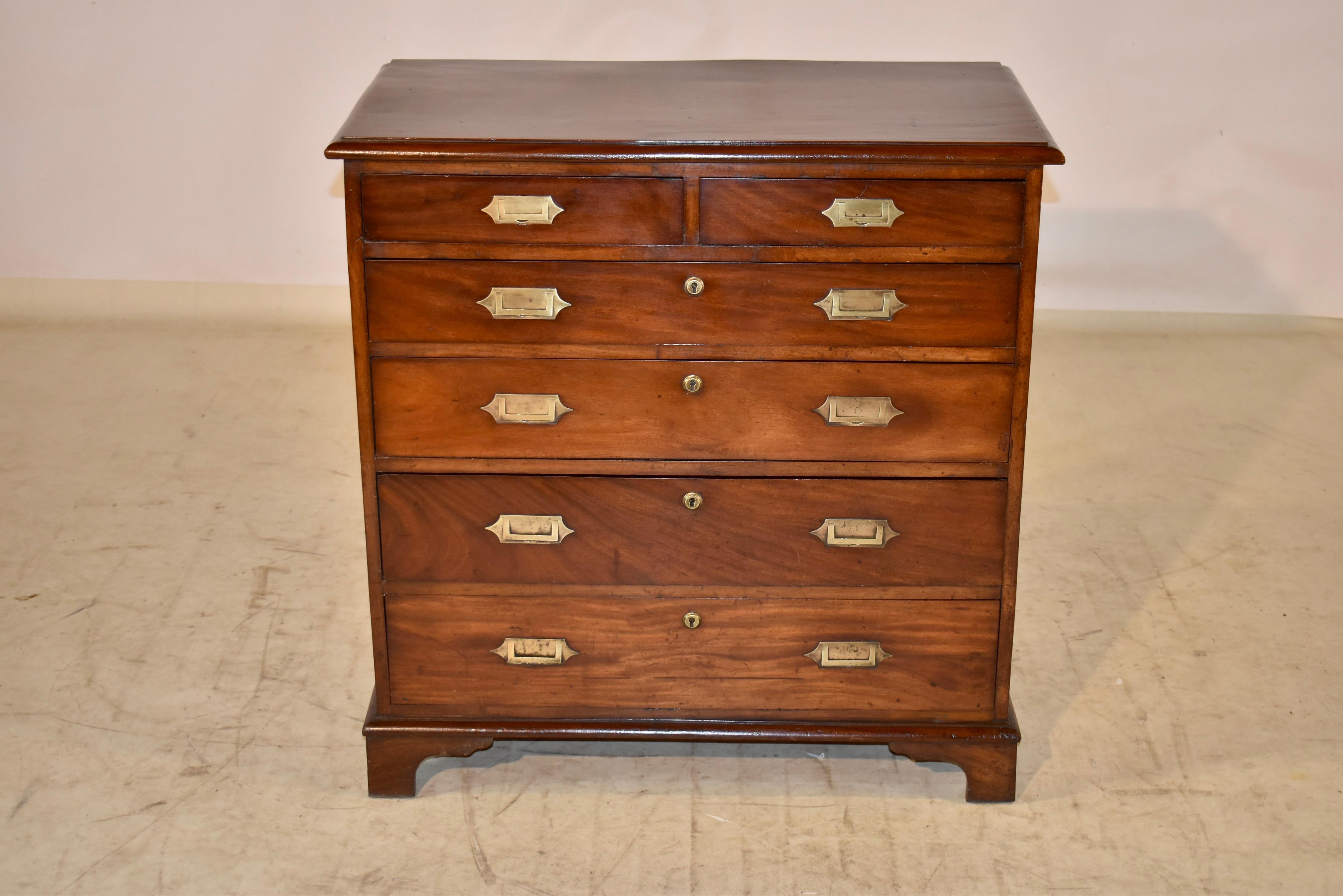 Early 19th century mahogany campaign chest of drawers from England. This is a wonderful chest with fabulous graining and color to the mahogany. The top is made from one solid board and the wood has so much movement in the grain, it was actually