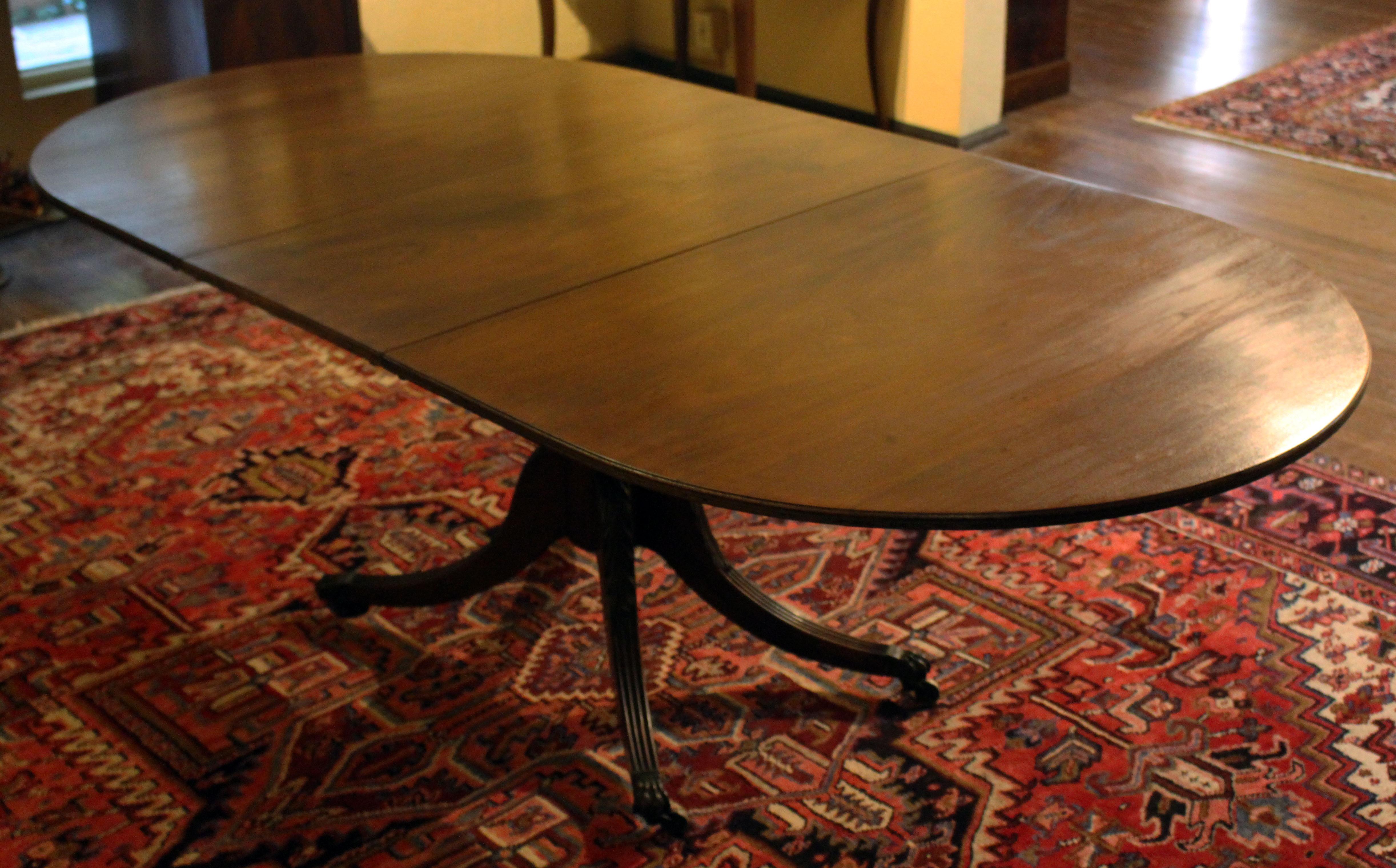 Early 19th century pedestal expanding dining table. English. Mahogany. Likely adapted in the early 20th century from a larger pedestal table to accomodate smaller townhouse living. Good Georgian well-turned pedestal with 4 splay legs with acanthus
