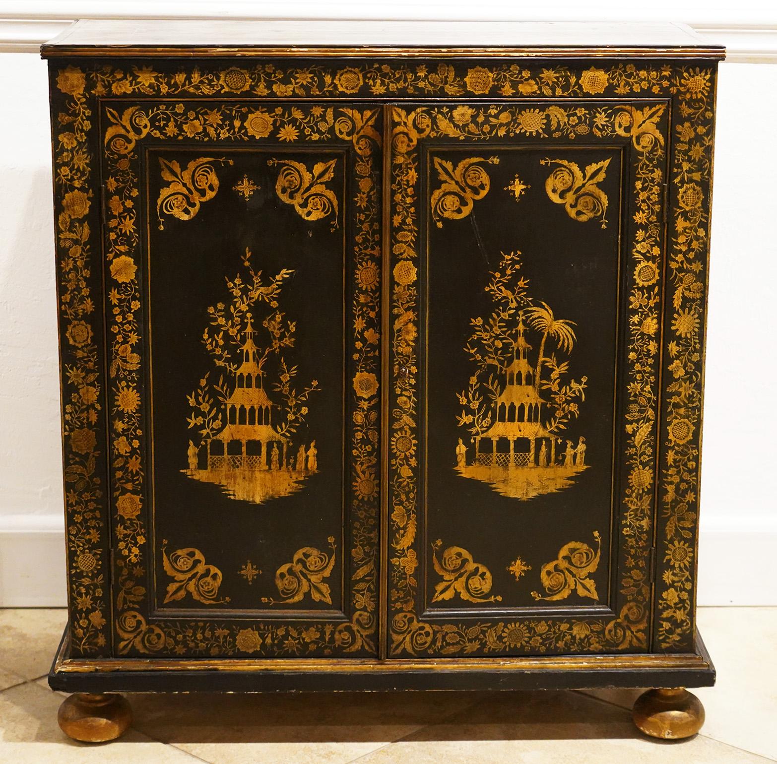 This fine Georgian chinoiserie gilt penwork side cabinet features a top with two pagoda landscape motifs above two doors opening up to a shelved interior and richly decorated with renderings of pagodas and people all surrounded by delicately painted