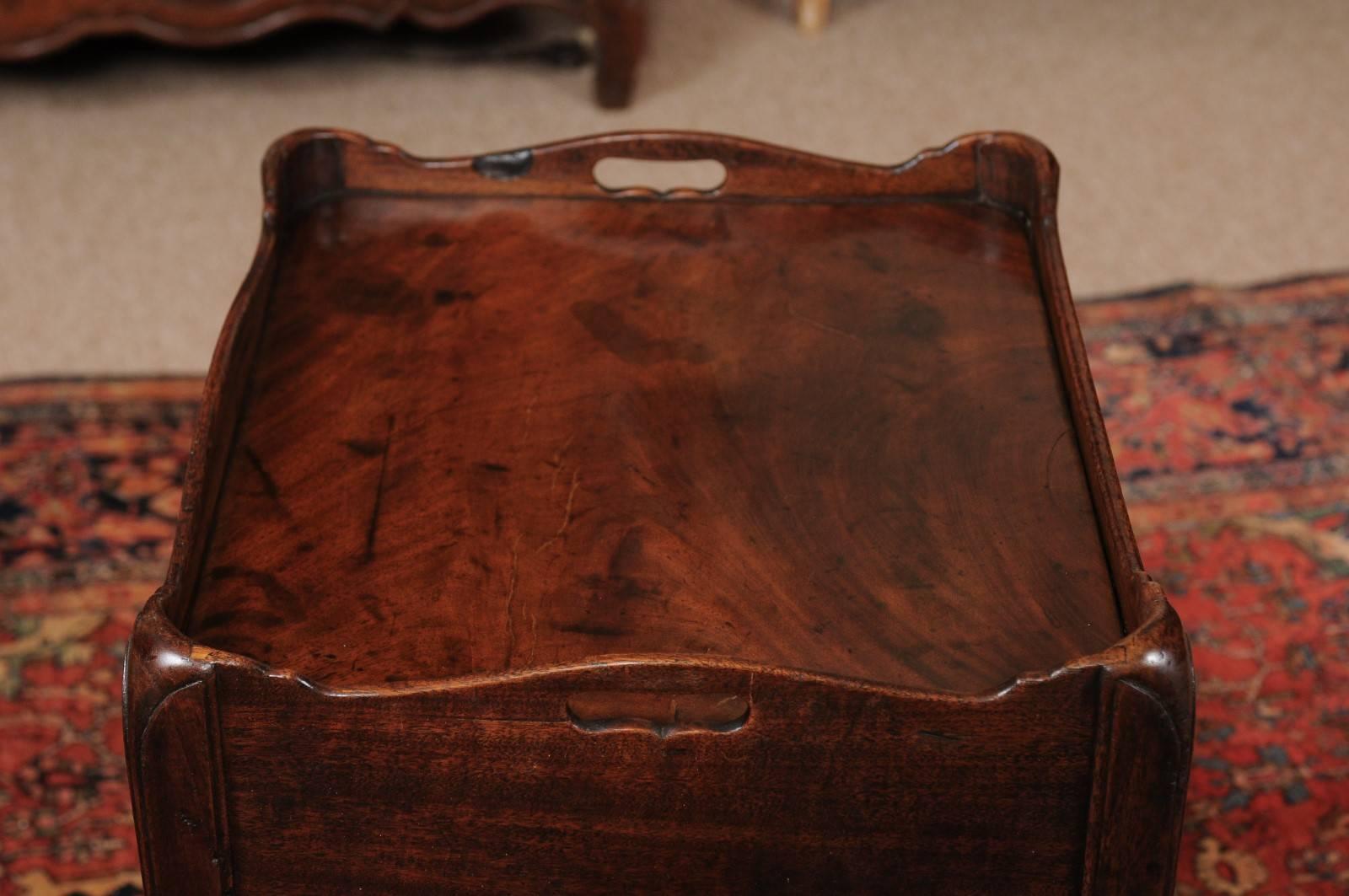 The early 19th century English George III mahogany bedside commode with tray top, tambour cabinet door and drawer below. 

  