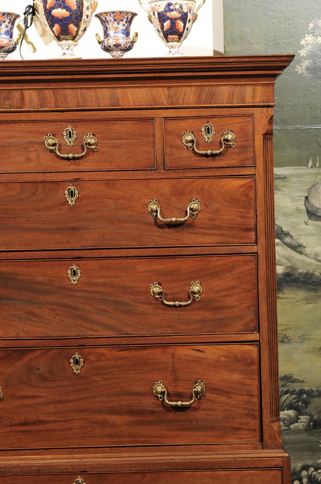 The early 19th century George III chest on chest in faded mahogany featuring molded cornice, 9 drawers and reeded sides terminating in ogee feet. 

.