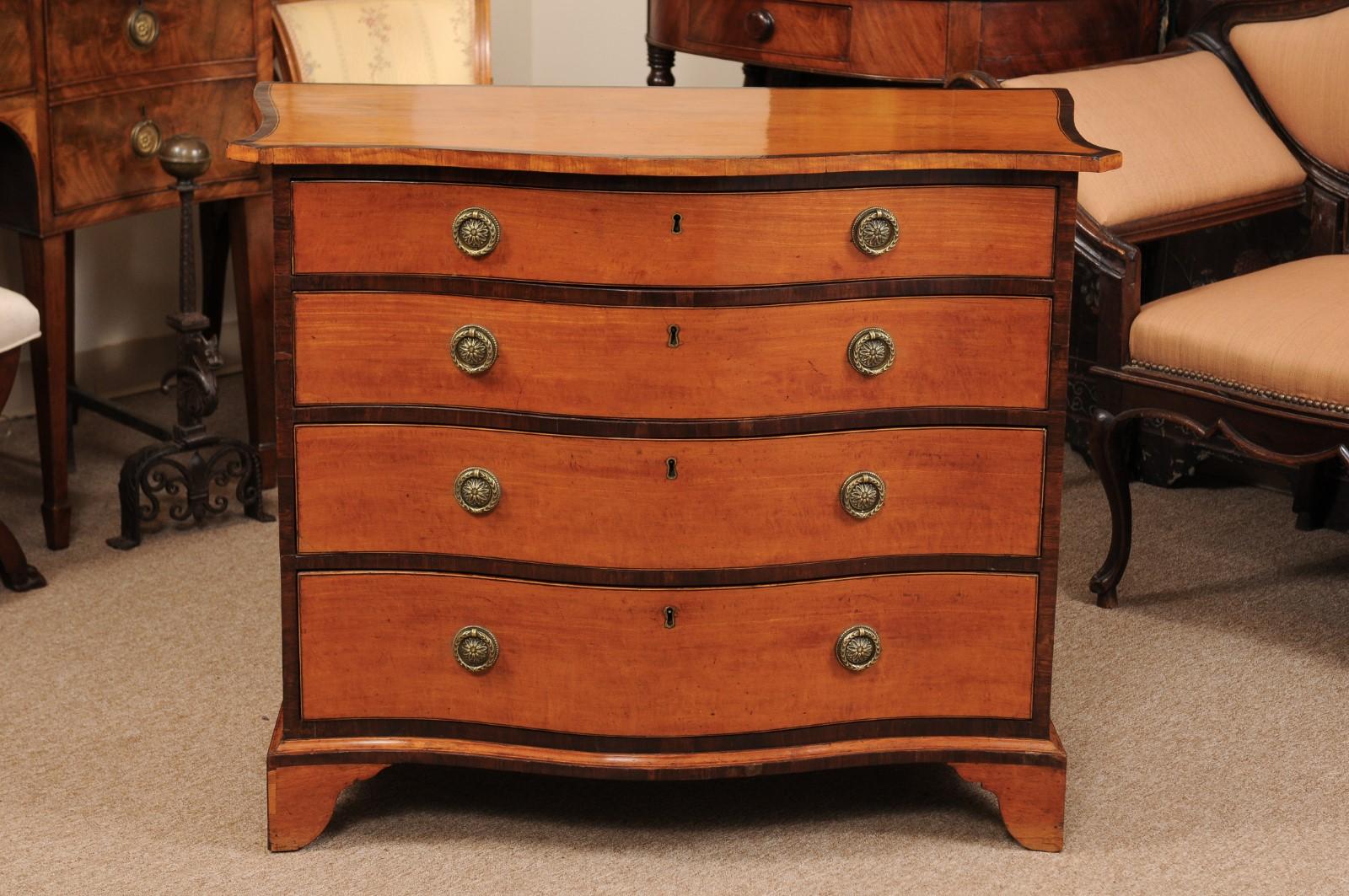 George III serpentine form chest of drawers in satinwood with four (4) drawers and bracket feet, England, early 19th century.