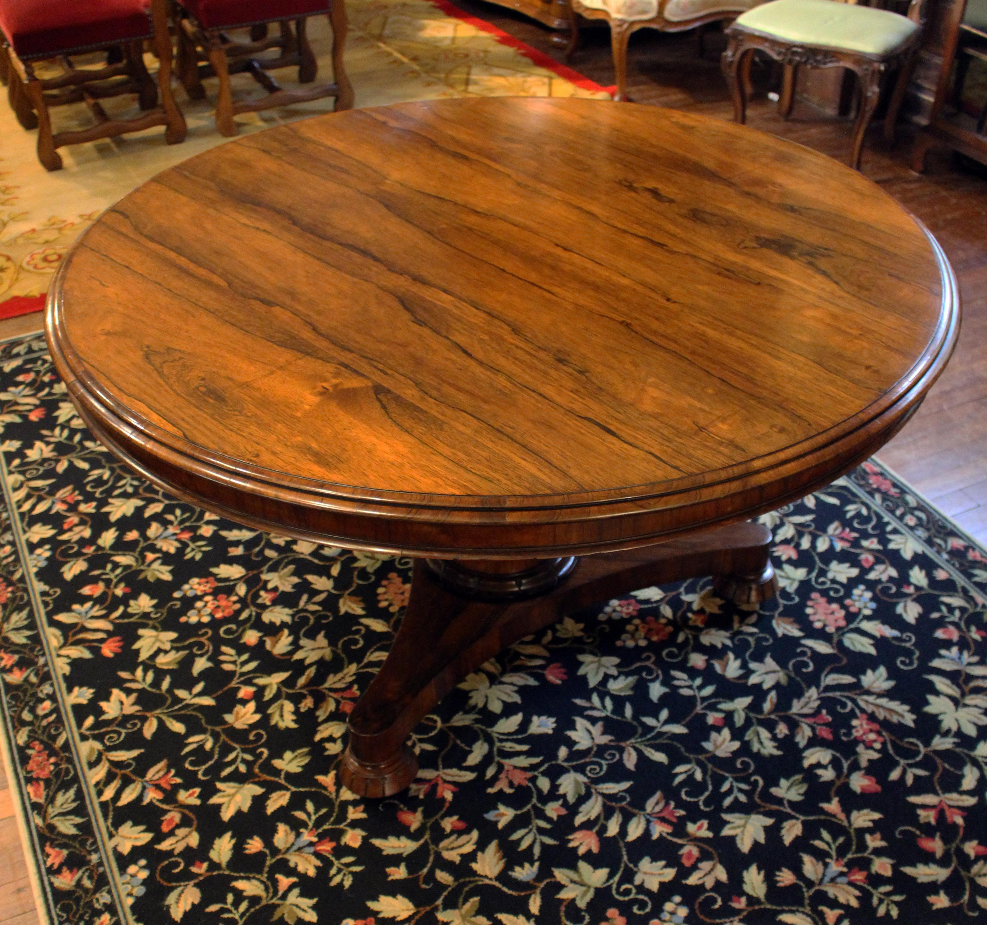 Early 19th century English loo or center table. Well figured rosewood veneers on mahogany & oak. Superb construction. Old, high quality butterfly joints under top to counteract shrinkage. Pedestal with brass label: 
