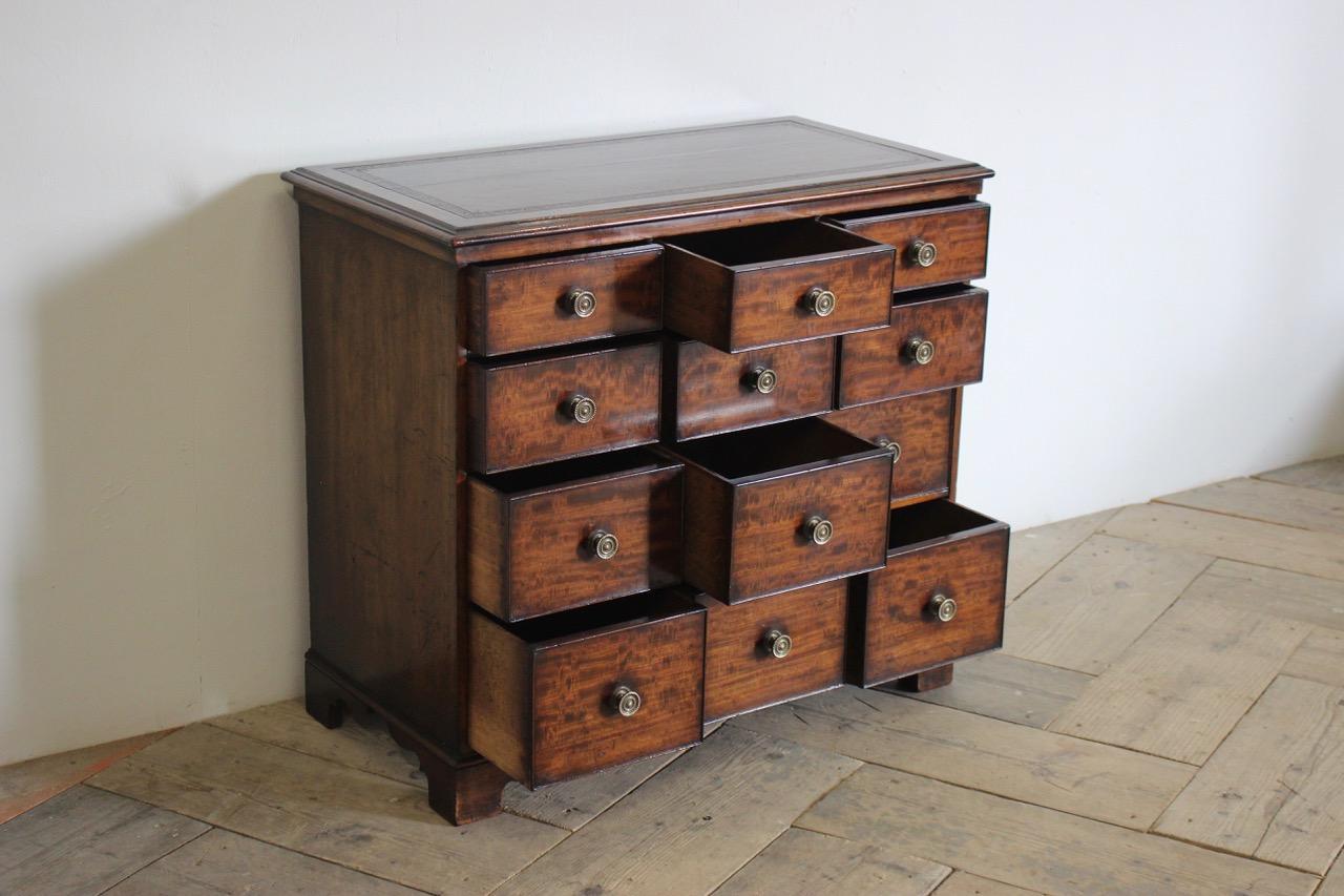 A very smart early 19th century English bank of drawers with a tooled leather top, of fine quality, with the original handles and drawers.
12 drawers.